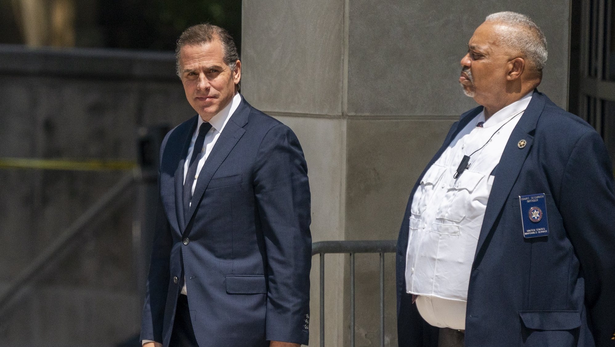 epa10770130 Hunter Biden (L) departs the US Federal District Court in Wilmington, Delaware, USA, 26 July 2023. Hunter Biden&#039;s hearing ended with him pleading not guilty after US District Judge Maryellen Noreika said she was not ready to accept the plea deal.  EPA/SHAWN THEW