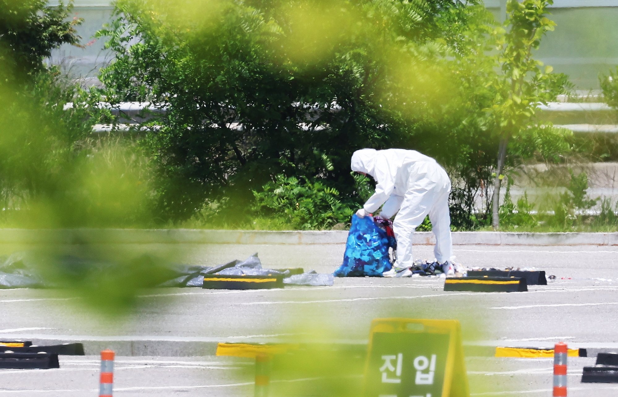 epa11385075 An official collects the debris of a balloon sent by North Korea at a shopping center in Siheung, west of Seoul, South Korea, 02 June 2024.  EPA/YONHAP SOUTH KOREA OUT