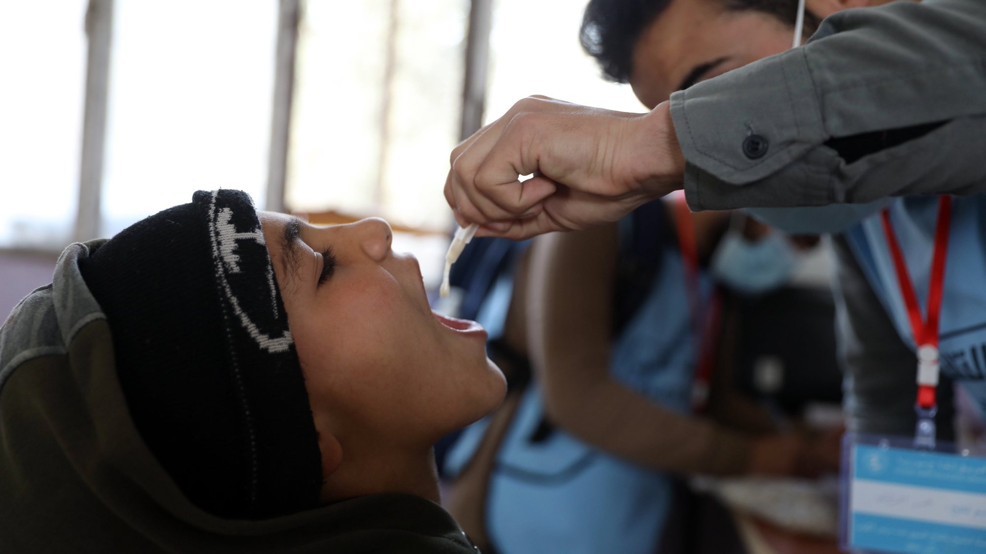 epa10510129 A child gets a cholera vaccination during a vaccination campaign at a school in Maaret Misrin town, Idlib province, Syria, 08 March 2023. The World Health Organization (WHO) said in a statement that a house-to-house 10-day cholera vaccination campaign was launched in earthquake-hit areas of northwest Syria in coordination with the United Nations Children’s Fund (UNICEF) and health authorities in the region, with an aim of giving 1.7 million doses of cholera vaccine to protect Syrians above one year of age, especially those living in the areas most severely impacted by the earthquake. The White Helmets group, the Syrian Civil Defense operating in the area, said on 28 February that the number of cholera deaths in northwestern Syria has risen to 22, with 568 cases of infection, noting that the earthquake on 06 February caused significant damage to infrastructure, water and sewage lines, increasing the risk of a disease outbreak.  EPA/YAHYA NEMAH