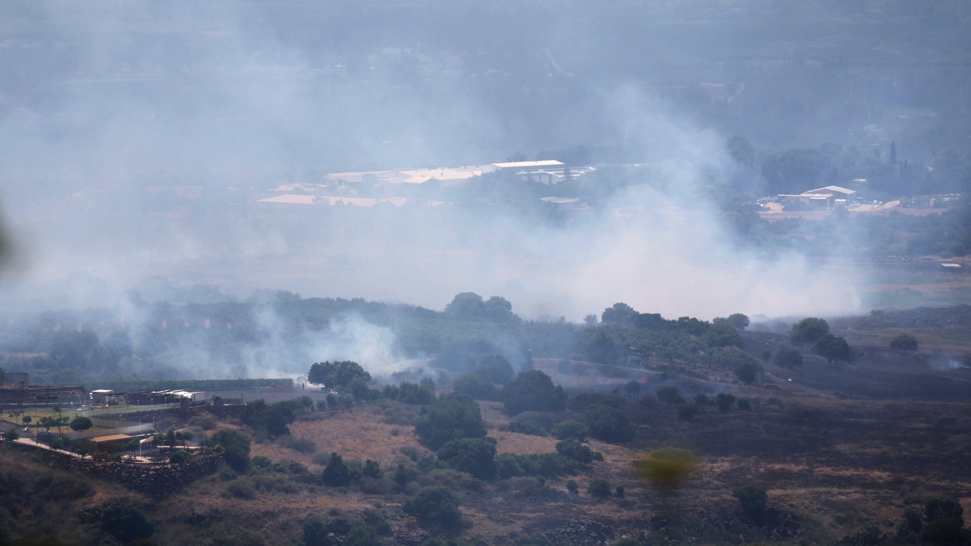 epa11399883 Smoke from a fire following strikes from Lebanon, near Banias, in the Israeli-annexed Golan Heights, 09 June 2024. The Israeli military stated on 09 June, that &#039;hostile aircraft&#039; entered northern Israel, two unmanned aerial vehicles (UAVs) were identified crossing from Lebanon. The aircraft fell in the northern Golan Heights area and no injuries were reported, the statement added. As a result of the UAV attacks, fires were ignited in the area and Israeli firefighters responded to the scene to extinguish the fires.  EPA/ATEF SAFADI