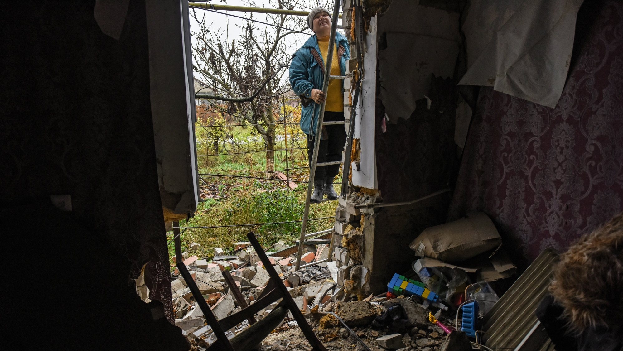 epa10316222 Svitlana repairs damages at her house in Posad-Pokrovske village, Kherson region, Ukraine, 20 November 2022. Ukrainian troops entered Kherson city on 11 November after Russian troops had withdrawn from the city. Kherson was captured in the early stage of the conflict, shortly after Russian troops had entered Ukraine in February 2022.  EPA/OLEG PETRASYUK