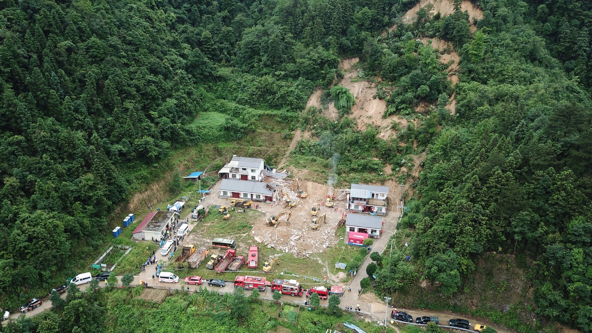 epa11432177 An aerial drone photo taken shows the site of a landslide in Douxi Village, central China&#039;s Hunan Province, 23 June 2024. The landslide that occurred in Douxi Village caused the collapse of four houses. The eight residents previously reported as missing have all been confirmed dead, according to Xinhua.  EPA/XINHUA / Chen Zhenhai CHINA OUT / UK AND IRELAND OUT  /       MANDATORY CREDIT  EDITORIAL USE ONLY  EDITORIAL USE ONLY