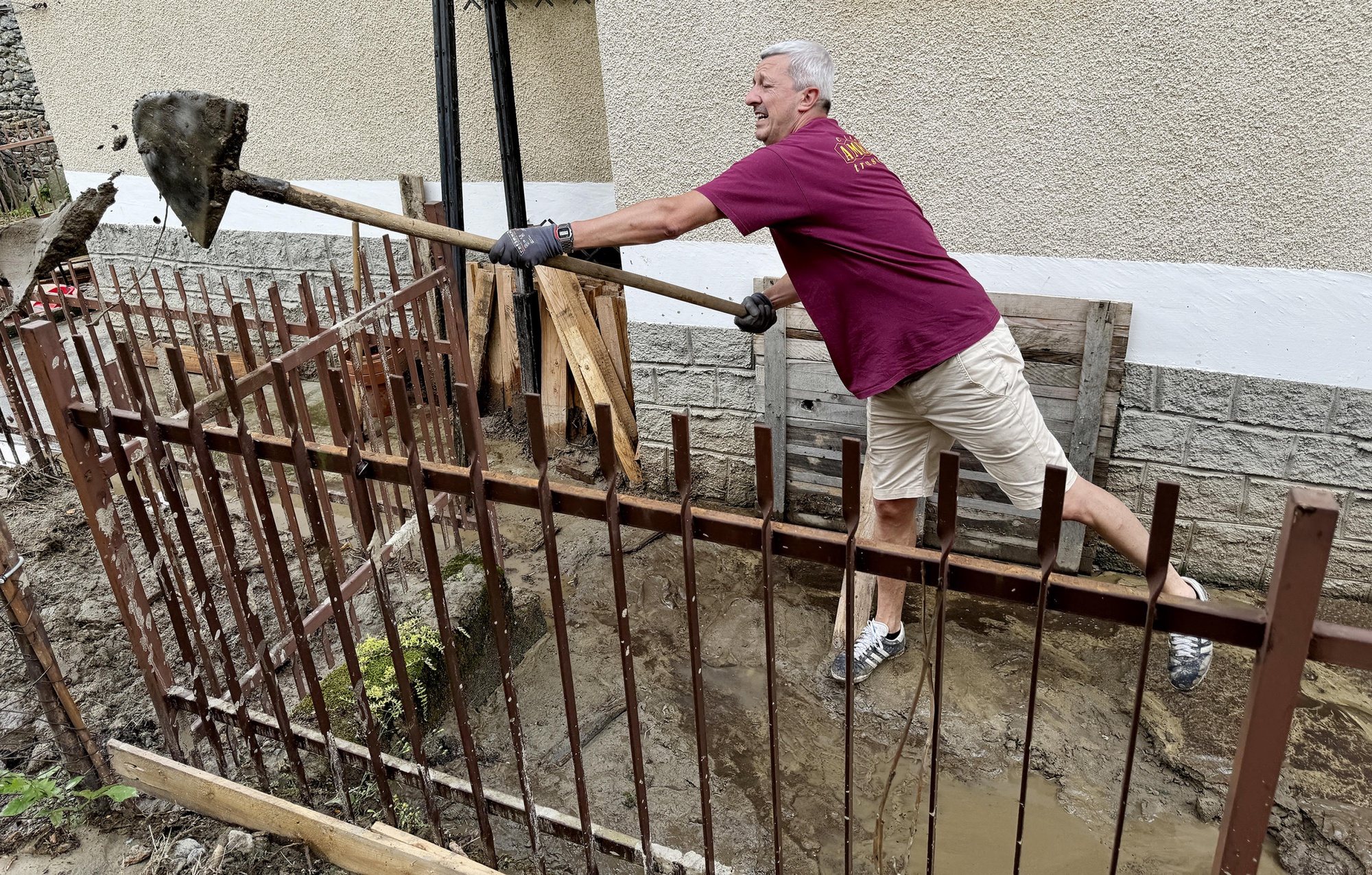 epa11447450 A resident shovels an area damaged by flooding in Chialamberto, Lanzo Valley, near Turin, Italy, 30 June 2024. Dozens of people had to leave their residence in the alpine valleys of Turin. Severe weather hit northern Italy, in particular Aosta Valley and Piedmont, leaving extensive damage due to landslides and floods. The town of Cogne remains isolated as the only road to reach it was heavily damaged in several places.  EPA/ALESSANDRO DI MARCO
