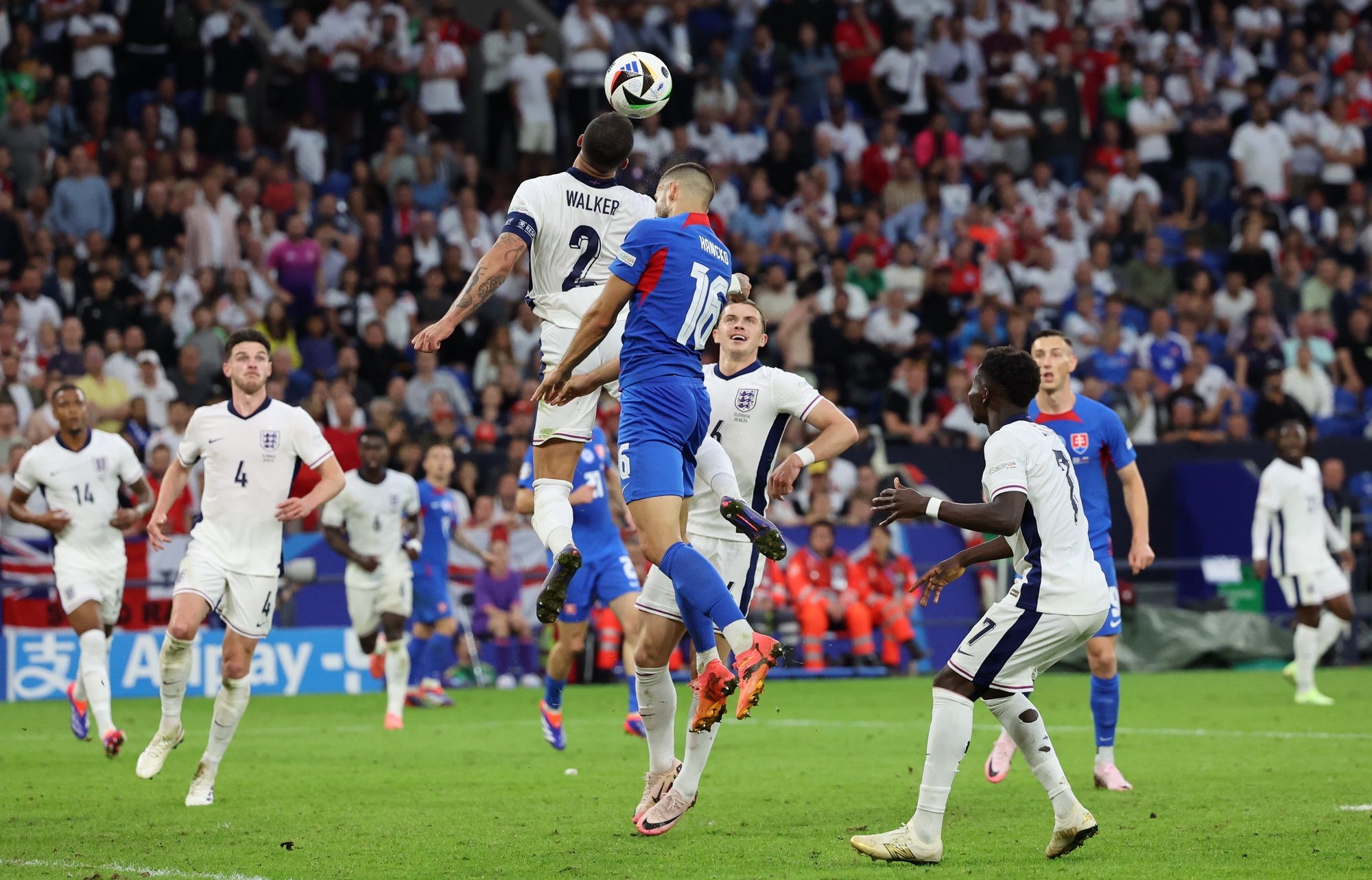 epa11448373 Kyle Walker of England goes for a header during the UEFA EURO 2024 Round of 16 soccer match between England and Slovakia, in Gelsenkirchen, Germany, 30 June 2024.  EPA/ABEDIN TAHERKENAREH