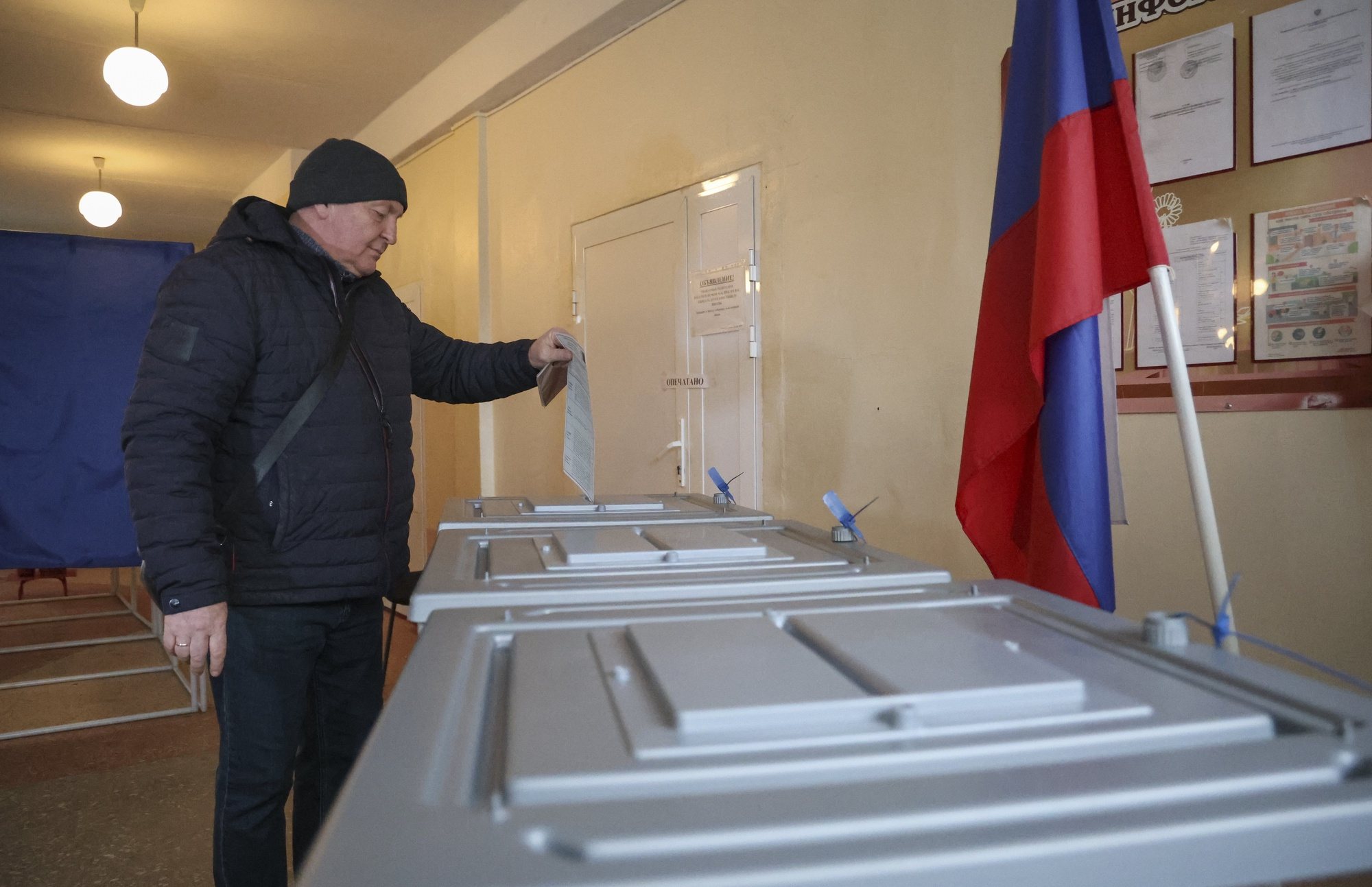 epa11225531 A man casts his ballot during the Russian presidential elections in Makeevka, Donetsk region, Russian controlled part of Ukraine, 17 March 2024. The Federation Council has scheduled presidential elections for March 17, 2024. Voting will last three days on 15-17 March. Four candidates registered by the Central Election Commission of the Russian Federation are vying for the post of head of state: Leonid Slutsky, Nikolai Kharitonov, Vladislav Davankov and Vladimir Putin. Residents of Russian-controlled territories of Ukraine are electing the President of Russia for the first time.  EPA/ALESSANDRO GUERRA
