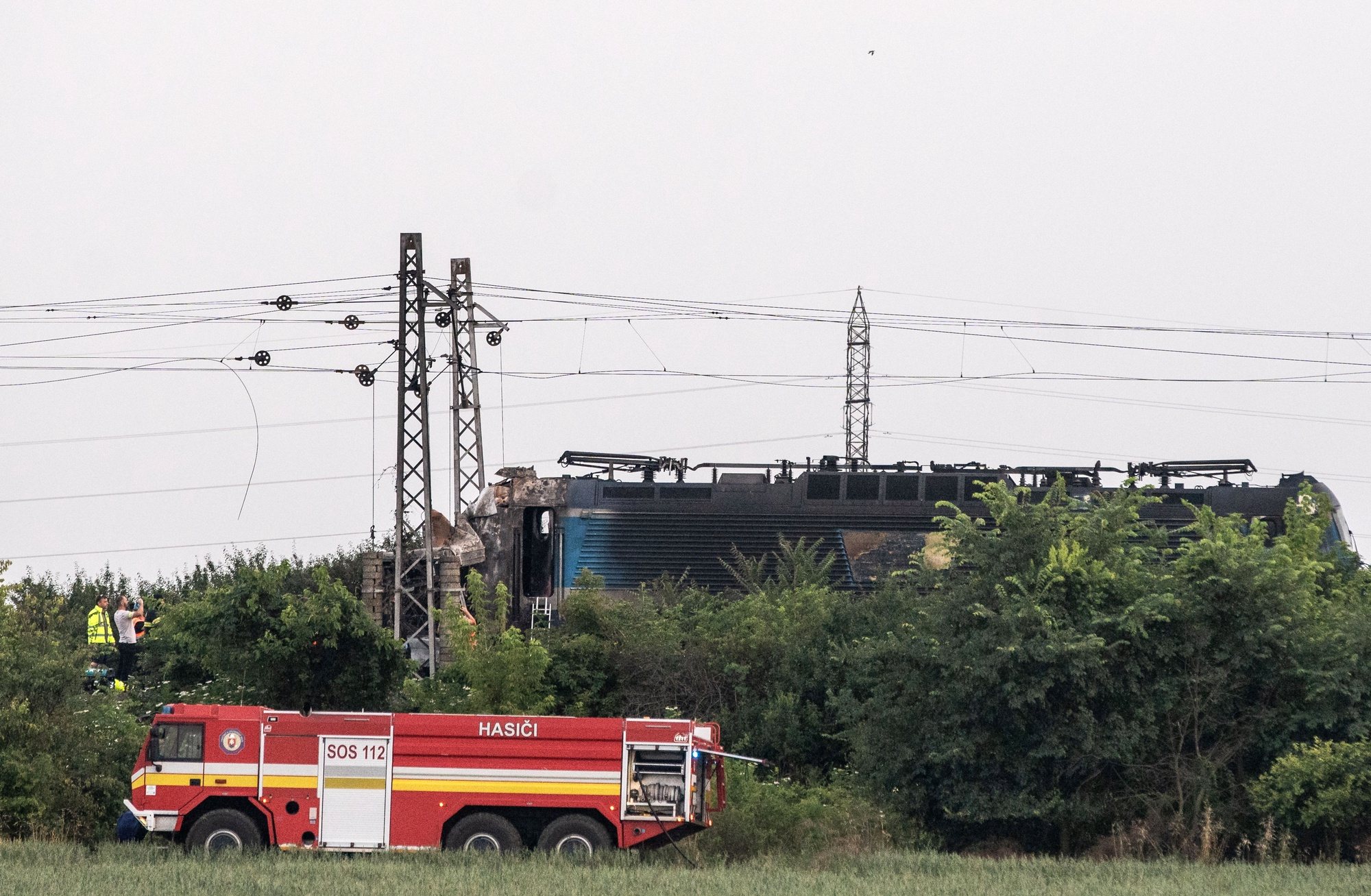 epa11442040 The scene in the aftermath of a train crash in the city of Nove Zamky, Slovakia, 27 June 2024. The accident happened at a railway crossing near the town of Nove Zamky in Southern Slovakia. Five ambulances and two helicopters have been despatched to the accident site. An express train carrying more than 100 passengers from Budapest to Prague crashed into a bus shortly after 5 p.m. local time, killing at least five people and injuring several others.  EPA/JAKUB GAVLAK