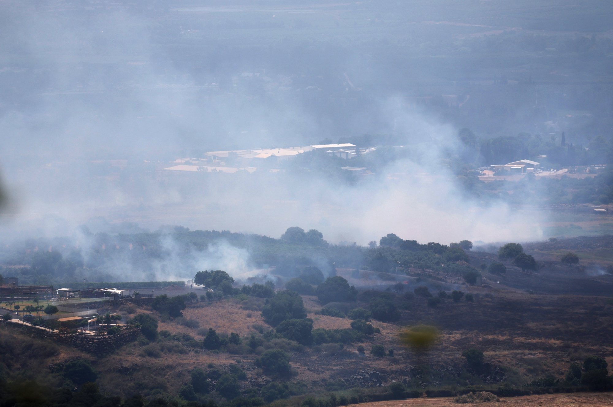 epa11399883 Smoke from a fire following strikes from Lebanon, near Banias, in the Israeli-annexed Golan Heights, 09 June 2024. The Israeli military stated on 09 June, that &#039;hostile aircraft&#039; entered northern Israel, two unmanned aerial vehicles (UAVs) were identified crossing from Lebanon. The aircraft fell in the northern Golan Heights area and no injuries were reported, the statement added. As a result of the UAV attacks, fires were ignited in the area and Israeli firefighters responded to the scene to extinguish the fires.  EPA/ATEF SAFADI
