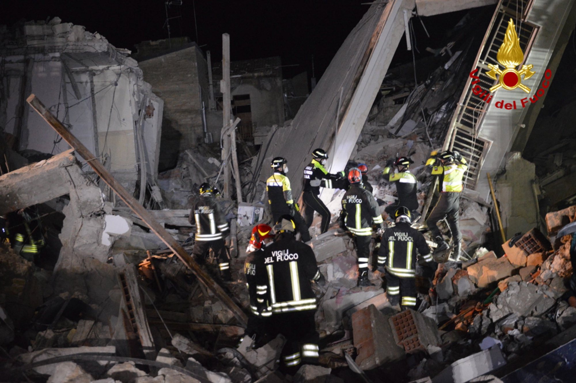 epa09637919 A handout picture provided by the Vigili del Fuoco shows rescue operations after blast caused by a gas leak in Ravanusa, Sicily, Italy, later in the night 11 December 2021 (issued 12 December 2021). Firefighters found a fourth body in the rubble of the collapsed buildings in Ravanusa. It could be a woman. Previously, the bodies of two women and a man were recovered; two survivors rescued, five people are still missing.  EPA/VIGILI DEL FUOCO HANDOUT BEST QUALITIY AVAILABLE HANDOUT EDITORIAL USE ONLY/NO SALES