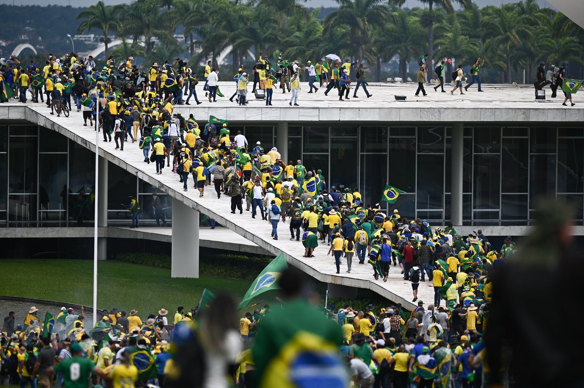 epa10396233 Bolsonaro supporters storm the National Congress in Brasilia, Brazil, 08 January 2023. Hundreds of supporters of former Brazilian President Jair Bolsonaro invaded the headquarters of the National Congress, and also Supreme Court and the Planalto Palace, seat of the Presidency of the Republic, in a demonstration calling for a military intervention to overthrow President Luiz Inacio Lula da Silva. The crowd broke through the cordons of security forces and forced their way to the roof of the buildings of the Chamber of Deputies and the Senate, and some entered inside the legislative headquarters.  EPA/ANDRE BORGES