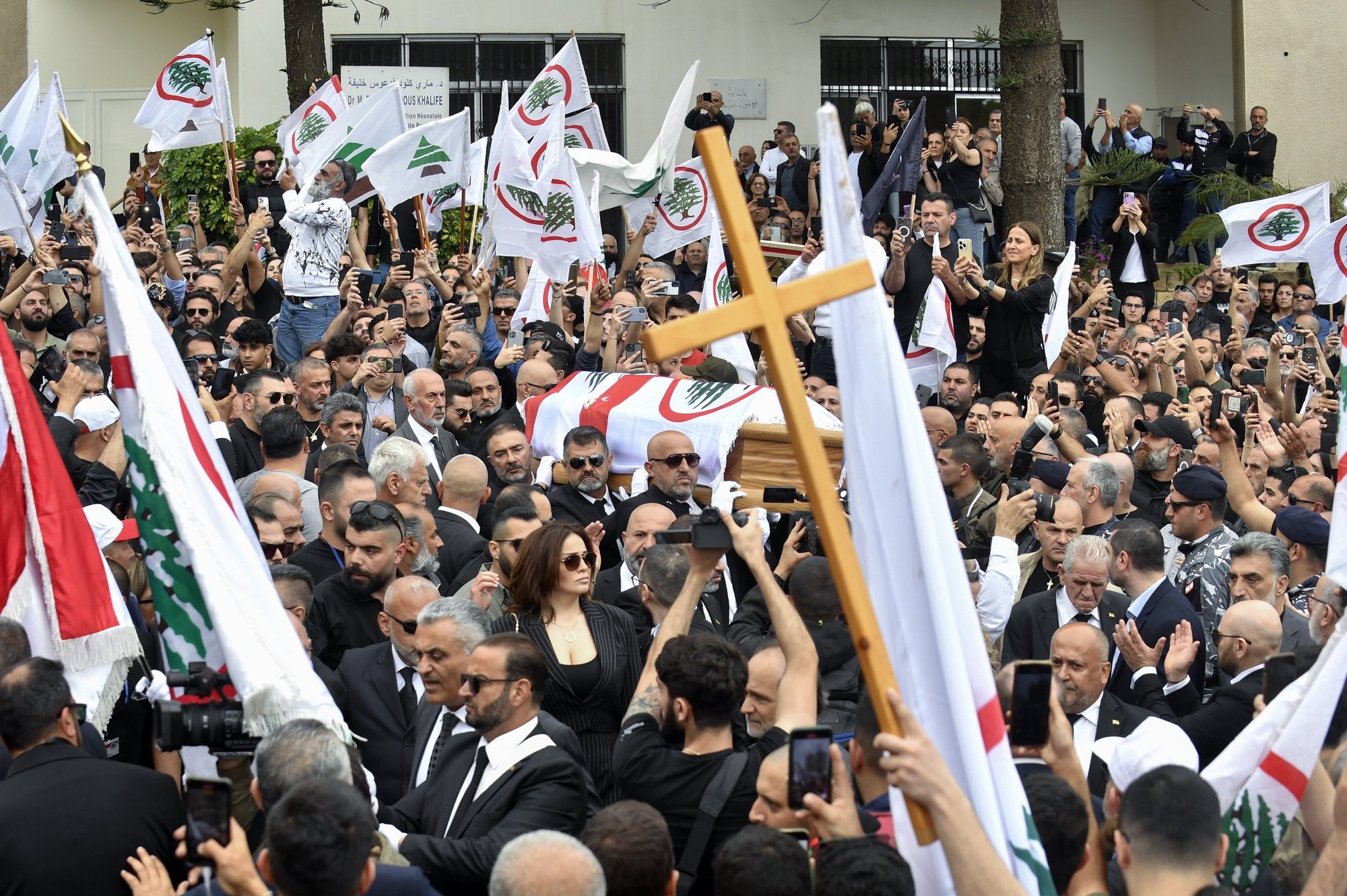 epa11274805 Mourners carry the coffin of Pascal Suleiman, an official of the Lebanese Forces Christian party, during his funeral in Byblos (Jbeil), Lebanon, 12 April 2024. According to the Lebanese army, Pascal Suleiman, a coordinator for the Christian Lebanese Forces party in the Jbeil area that opposes the Syrian government and its Lebanese ally Hezbollah, was killed by Syrian kidnappers when the gang tried to steal his car on 08 April.  EPA/WAEL HAMZEH