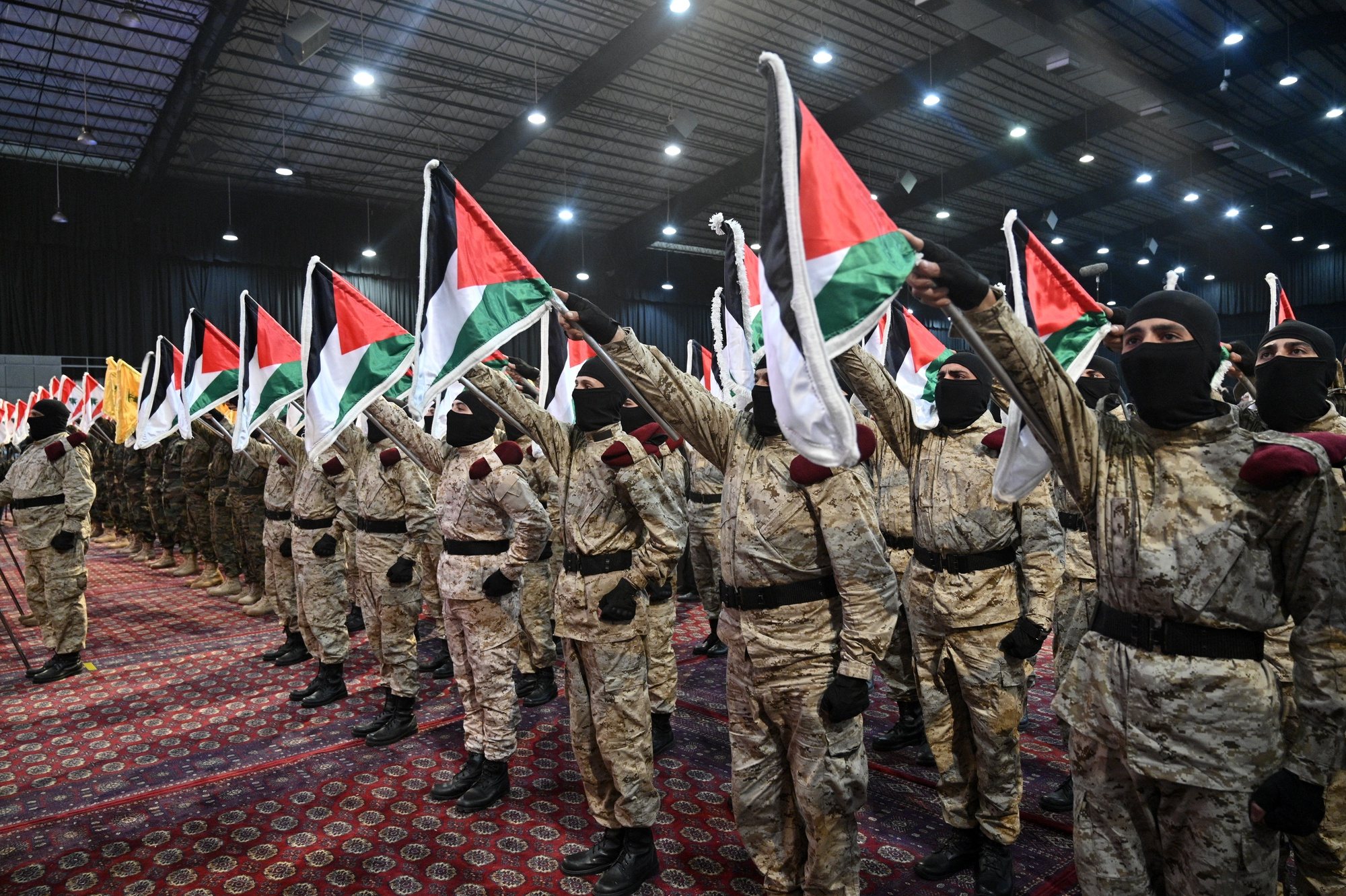 epa11260747 Hezbollah members stand in formation and hold up Palestinian flags during a gathering to commemorate Al Quds Day (Jerusalem Day) in a suburb of Beirut, Lebanon, 05 April 2024. Al Quds Day was declared in 1979 by the late Ayatollah Khomeini, founder of the Islamic Iranian Republic, who called on the world&#039;s Muslims to show solidarity with Palestinians on the last Friday of the fasting month of Ramadan.  EPA/WAEL HAMZEH
