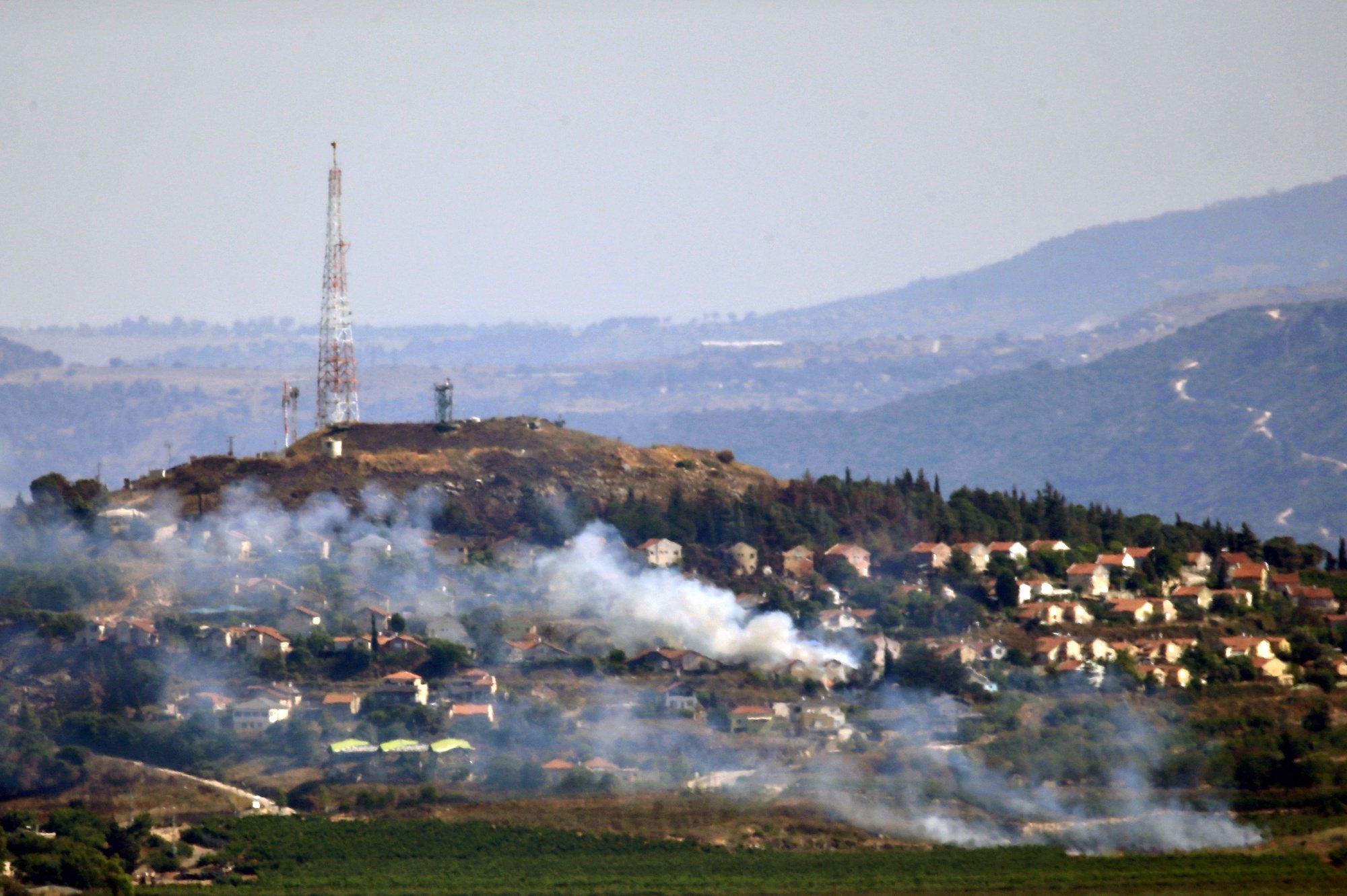 epaselect epa11439957 Smoke billows in the Israeli northern town of Metulla from cross-border rockets launched by Hezbollah from the Lebanese side, as seen from Khiam village, Lebanon, 26 June 2024. According to an Israeli army report, the IDF fighter jets on 26 June struck Hezbollah military structure and observation post and other infrastructure in the areas of Kfarchouba, Ayta ash Shab, and Khiam in southern Lebanon. Hezbollah said in statement the group targeted buildings in Metulla with &#039;appropriate weapons&#039; in response to the Israeli attacks on southern villages.  EPA/STR