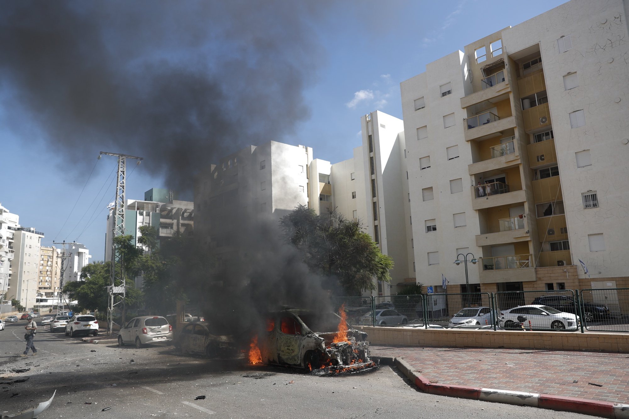 epa10904810 A burning vehicle in the Israeli city of Ashkelon following rocket launches from Gaza, 07 October 2023. Rocket barrages were launched from the Gaza Strip early Saturday in a surprise attack claimed by the Islamist movement Hamas.  EPA/ATEF SAFADI