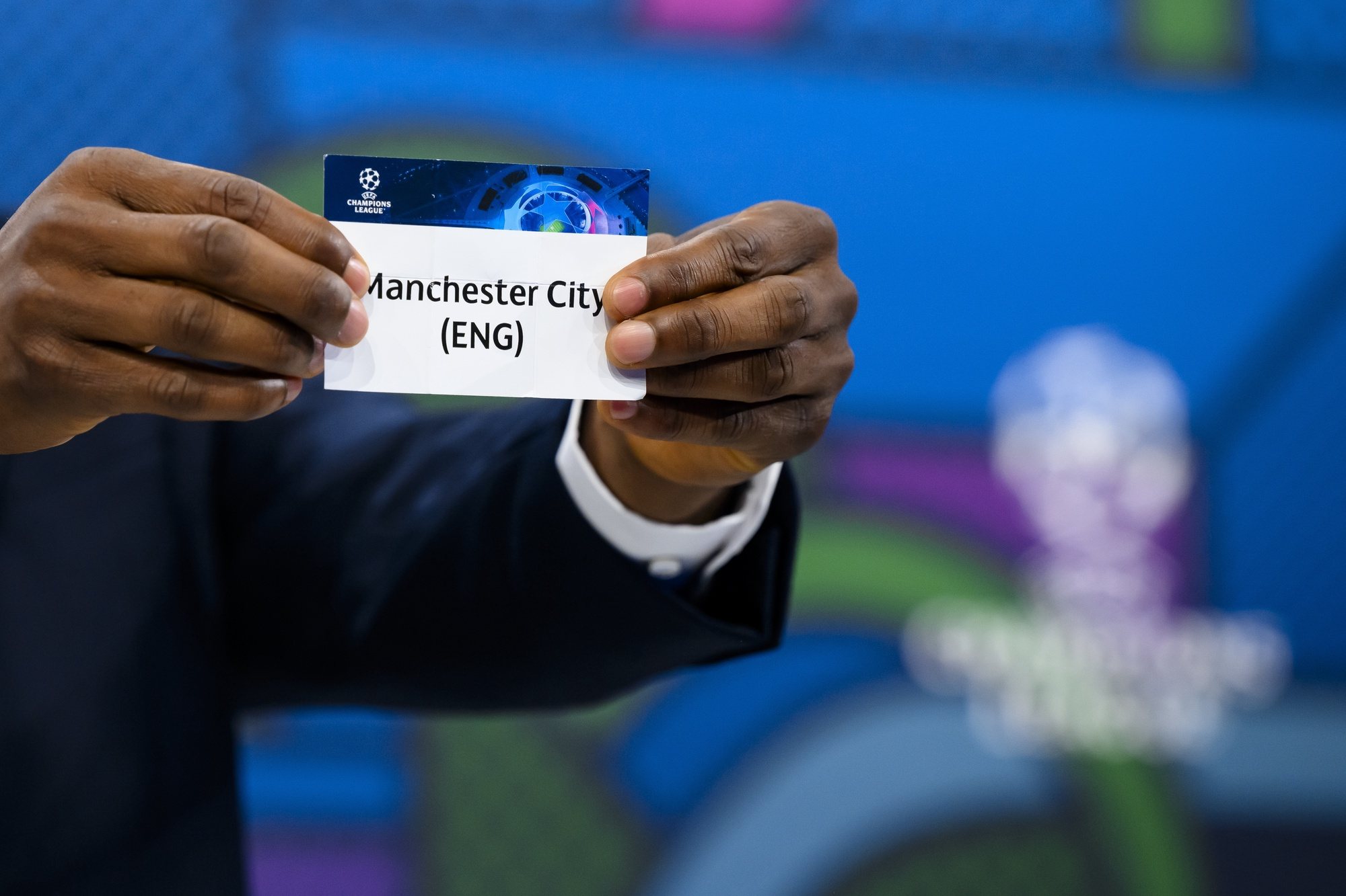 epa11222062 Former Nigeria soccer player John Obi Mikel shows a ticket with Manchester City during the draw for the UEFA Champions League quarter-finals at the UEFA headquarters in Nyon, Switzerland, 15 March 2024.  EPA/JEAN-CHRISTOPHE BOTT