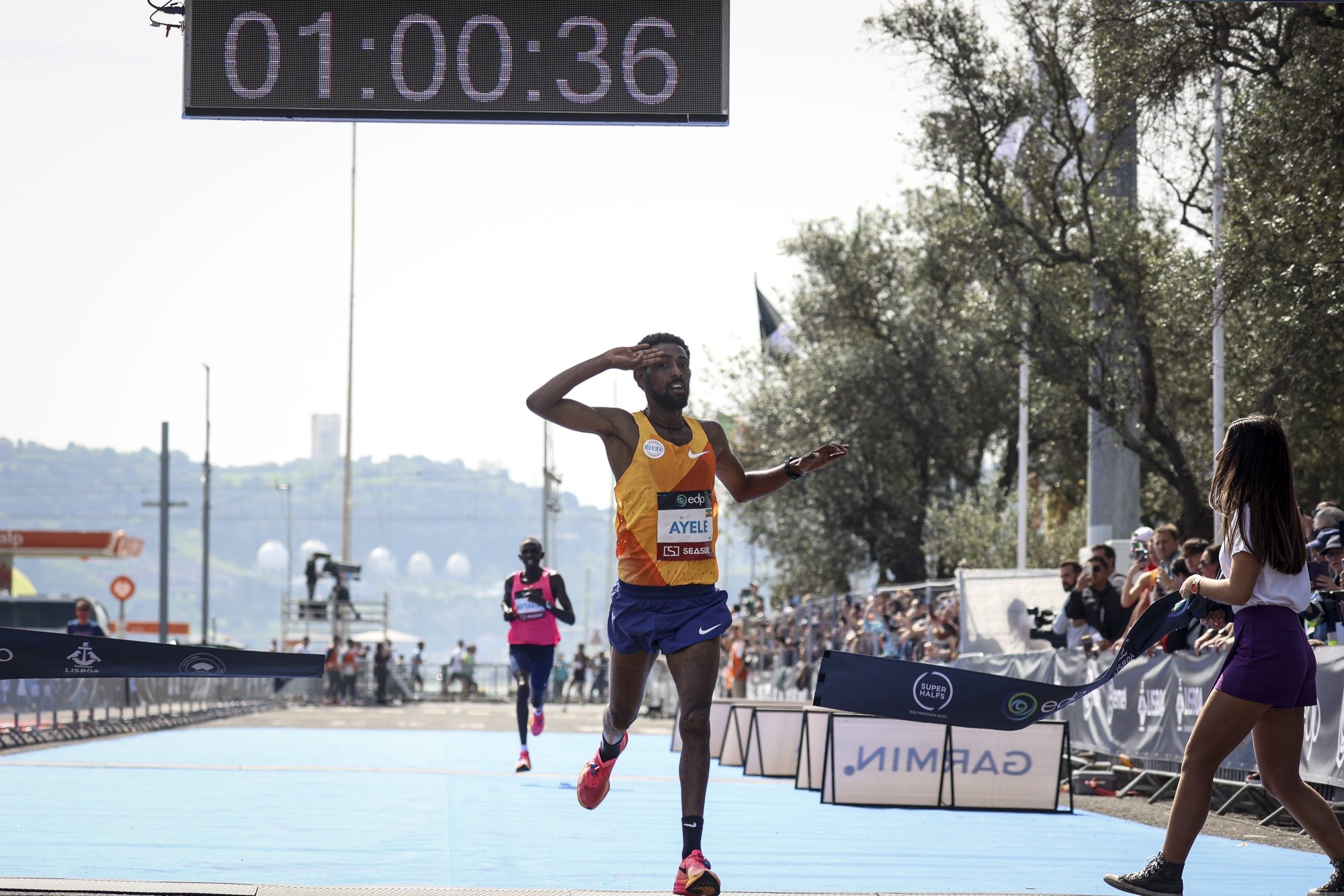 Ethiopian runner Dinkalem Ayele (C) celebrates after won the Lisbon Half Marathon, in Lisbon, Portugal, 17 March 2024. FILIPE AMORIM/LUSA