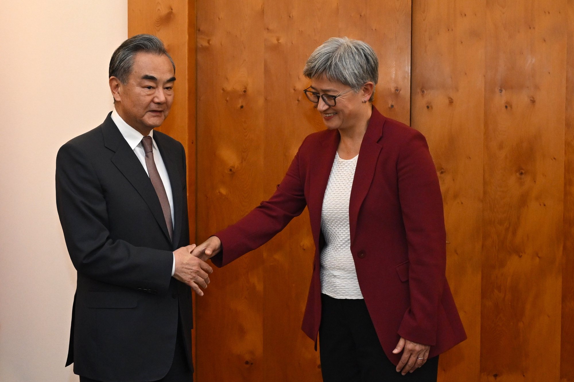epa11230473 Australian Foreign Minister Penny Wong (R) shakes hands with Chinese Foreign Minister Wang Yi (L) during a meeting at Parliament House, in Canberra, Australia, 20 March 2024.  EPA/LUKAS COCH AUSTRALIA AND NEW ZEALAND OUT