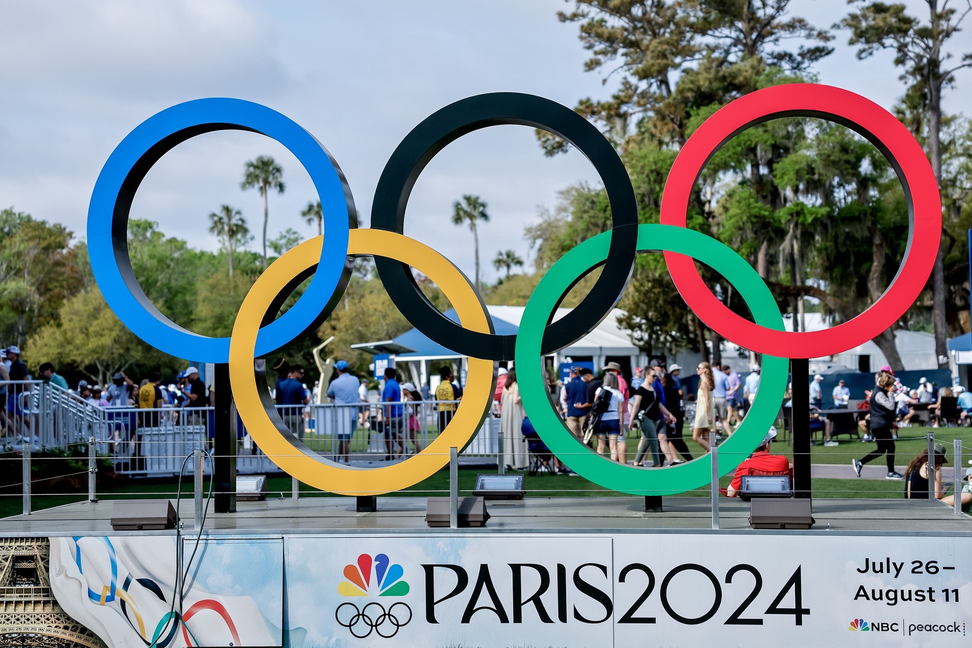 epa11224048 The Olympic Rings logo, promoting the Paris 2024 Summer Olympic Games, are on display in the fan experience area during the third round of The Players Championship golf tournament at TPC Sawgrass in Ponte Vedra Beach, Florida, USA, 16 March 2024.  EPA/ERIK S. LESSER