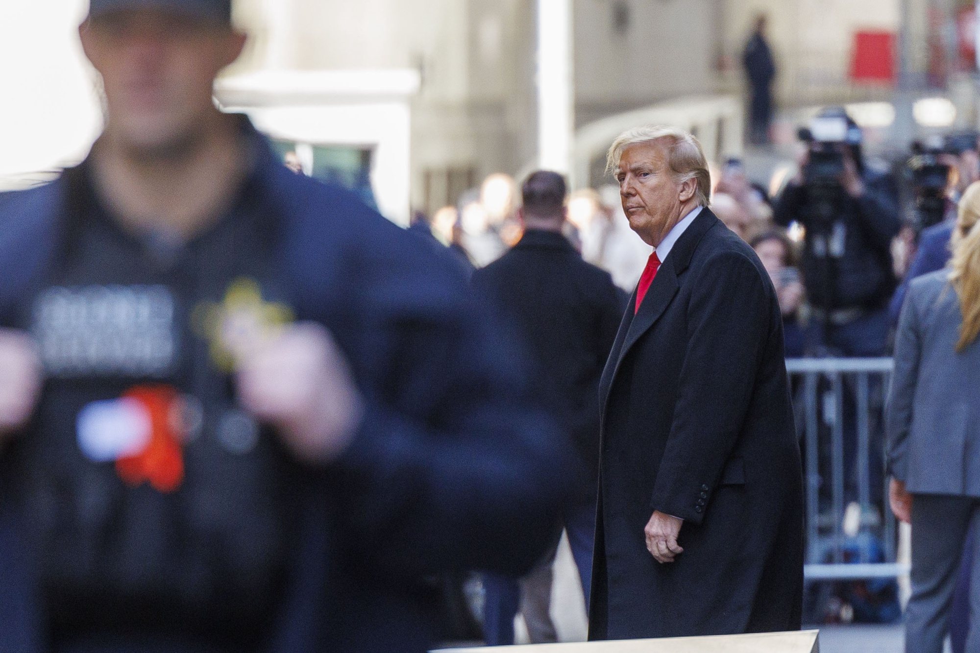 epa11243236 Former US president Donald Trump (C) departs 40 Wall Street after a press conference about his case in criminal court in New York, New York, USA, 25 March 2024. A judge ruled on 25 March that the hush-money trial against former US President Trump will begin on 15 April 2024. Trump is facing 34 felony counts of falsifying business records related to payments made to adult film star Stormy Daniels during his 2016 presidential campaign.  EPA/SARAH YENESEL