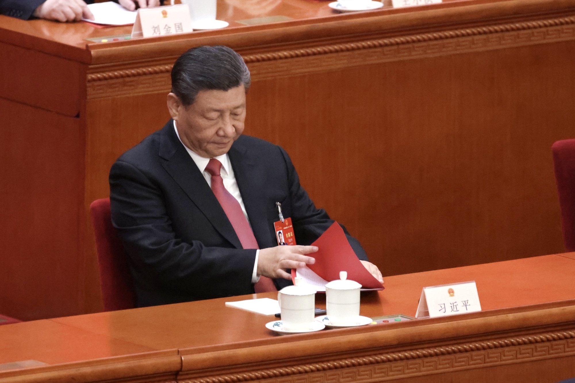 epa11213960 Chinese President Xi Jinping checks documents during the closing meeting of the second session of the 14th National People&#039;s Congress (NPC) at the Great Hall of the People in Beijing, China, 11 March 2024. China holds two major annual political meetings, the National People&#039;s Congress (NPC) and the Chinese People&#039;s Political Consultative Conference (CPPCC), which run alongside each other and are known as &#039;Lianghui&#039; or &#039;Two Sessions.&#039;  EPA/ANDRES MARTINEZ CASARES
