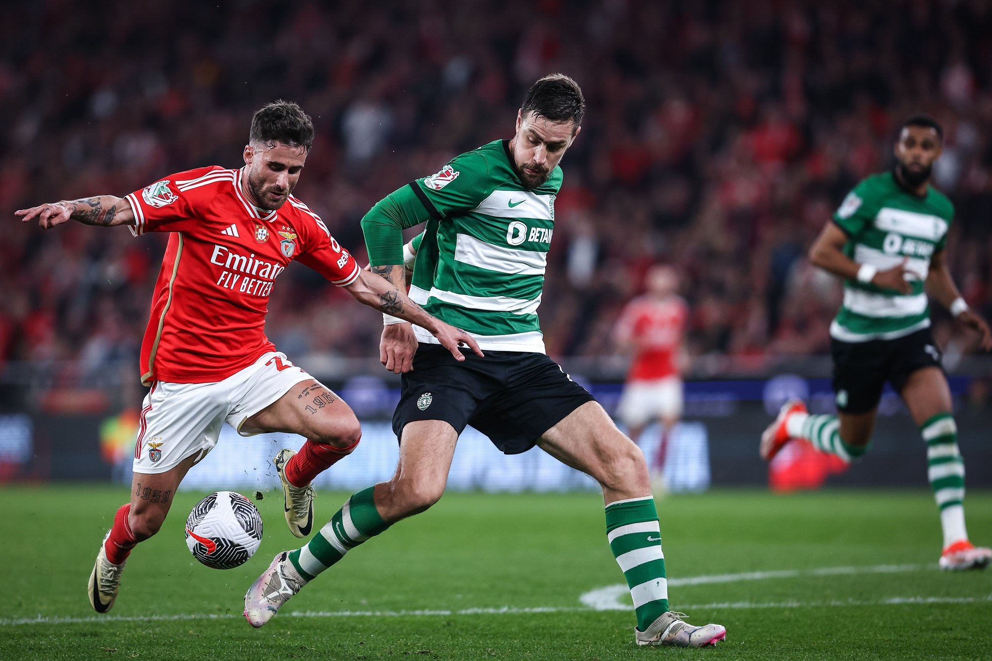 Benfica player Rafa (L) in action against Sporting player Sebastian Coates (C) during the Portugal Soccer Cup second leg semi-final match held at Luz Stadium, in Lisbon, Portugal, 02 April 2024. RODRIGO ANTUNES/LUSA