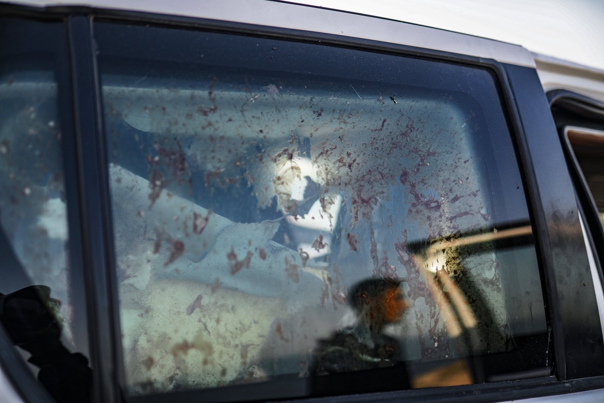 epa11255116 Blood is visible on the window of a destroyed car of the NGO World Central Kitchen (WCK) along Al Rashid road, between Deir Al Balah and Khan Younis in the southern Gaza Strip, 02 April 2024. According to the Palestinian Red Crescent, at least four people from the NGO World Central Kitchen (WCK) were killed when a missile hit their convoy in Deir al Balah while they were on their way from Rafah to Gaza City to receive fresh aid delivered by the Open Arms vessel. The victims were confirmed to be a British, a Polish and an Australian citizen, while the nationality of the fourth victim was still unknown.  EPA/MOHAMMED SABER
