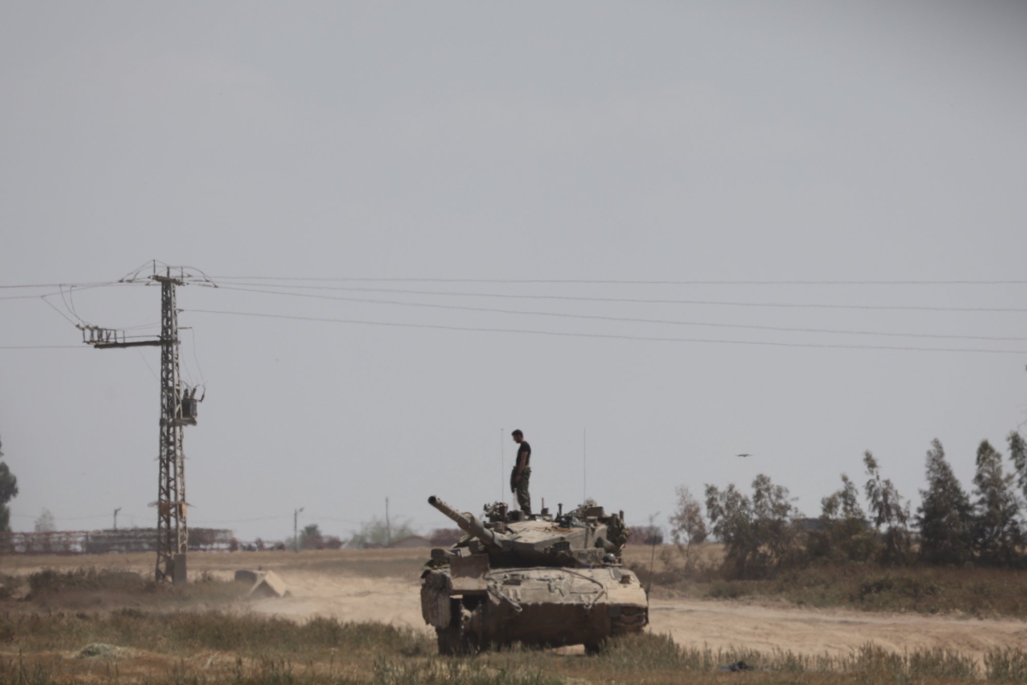 epa11263792 An Israeli soldier on a tank near the border to the Gaza Strip, in southern Israel, 07 April 2024. Israel marks six months since the October 07 attacks, as 134 hostages are currently still being held captive in Gaza, according to the Israeli IDF. More than 33,000 Palestinians and over 1,450 Israelis have been killed, according to the Palestinian Health Ministry and the Israel Defense Forces (IDF), since Hamas militants launched an attack against Israel from the Gaza Strip on 07 October 2023, and the Israeli operations in Gaza and the West Bank which followed it.  EPA/ABIR SULTAN  EPA-EFE/ABIR SULTAN