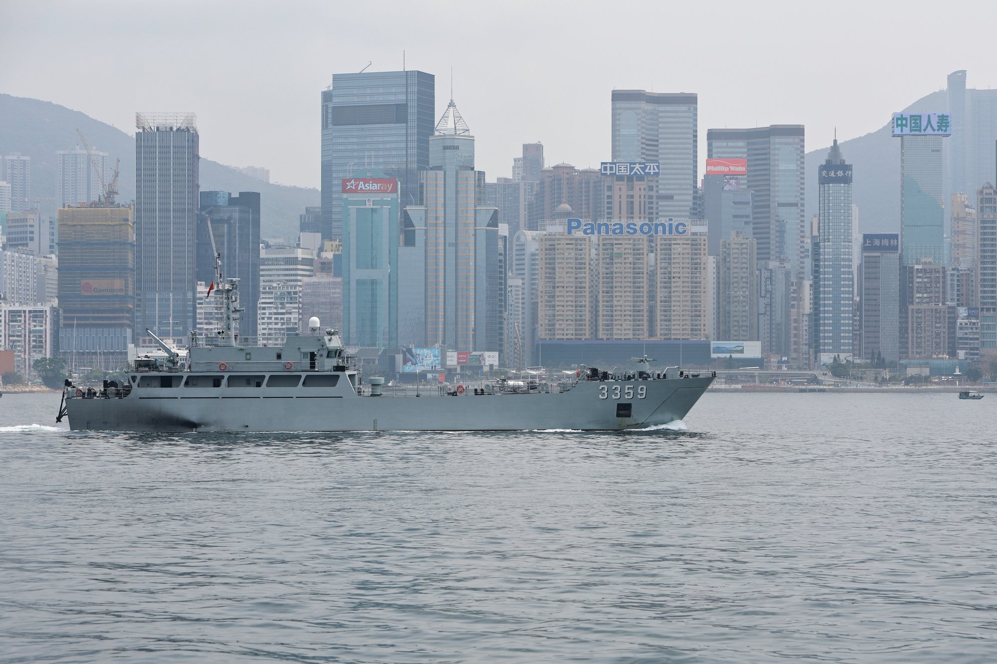 epa11249174 A Chinese military vessel sails through the Victoria Harbour against the backdrop of the Central Business District in Hong Kong, China, 29 March 2024. Foreign countries such as the United States, the United Kingdom, Australia and some European countries have expressed concerns over the city’s Article 23 and National Security Law, which are said to have impacts on business, freedom of speech, freedom of the press and other human rights.  EPA/DANIEL CENG