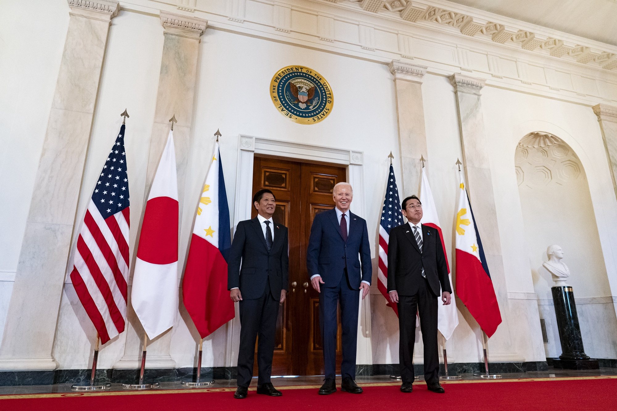 epa11273919 US President Joe Biden, center, with Ferdinand Marcos Jr., Philippines&#039; president, left, and Fumio Kishida, Japan&#039;s prime minister, right, arrive during a trilateral meeting in the East Room of the White House in Washington, DC, USA, on 11 April 2024. US President Joe Biden is set to unveil joint military patrols and training with the Philippines and Japan as the allies seek to counter an increasingly assertive China in the South China Sea.  EPA/Al Drago / POOL