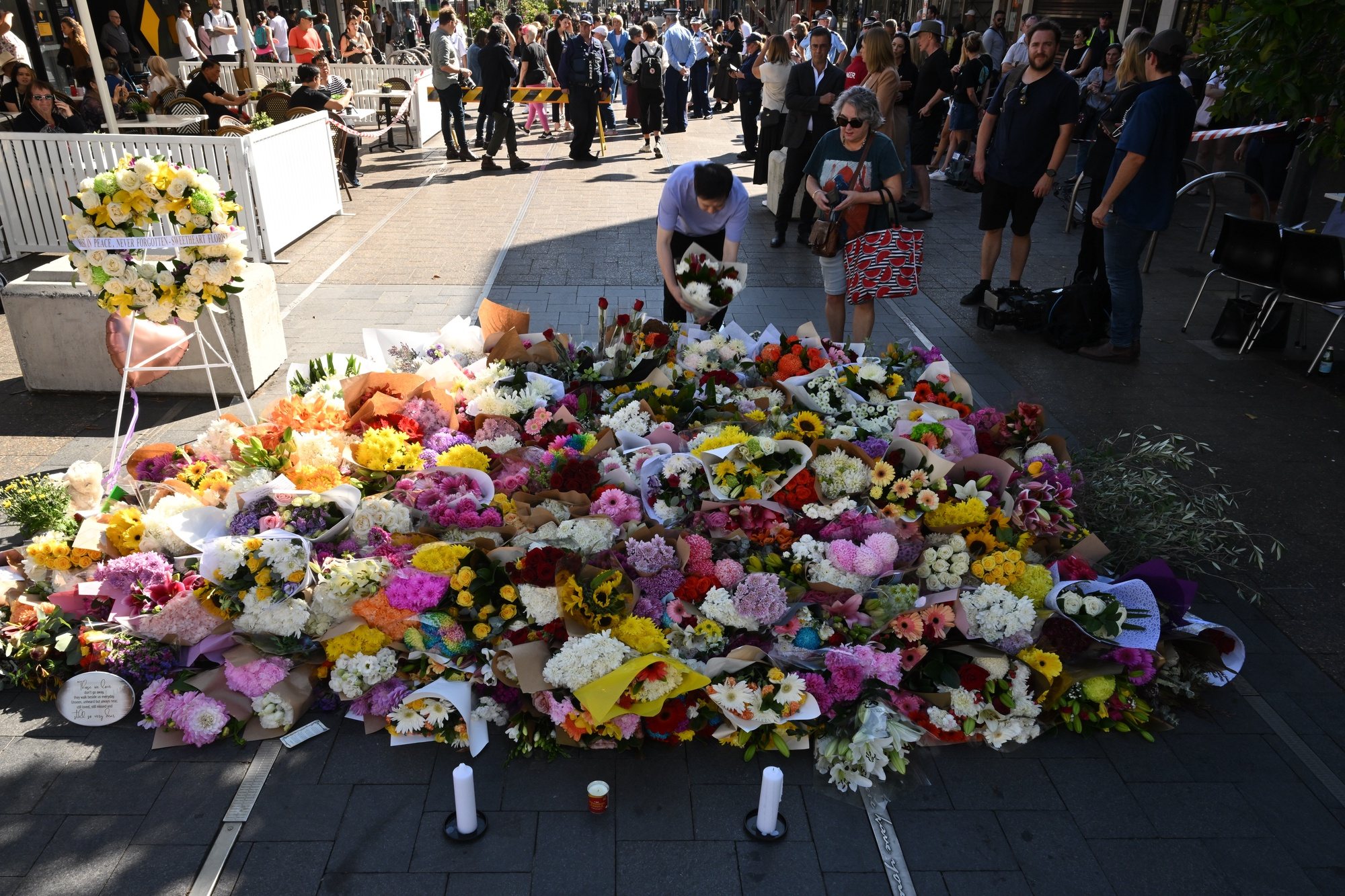 epa11277739 Flowers are placed at the scene of the 13 April stabbing rampage at Bondi Junction in Sydney, Australia, 14 April 2024. The man who fatally stabbed six people in an attack at a Sydney shopping center has been identified as 40-year-old Joel Cauchi, who moved to Sydney from Queensland last month.  EPA/DEAN LEWINS AUSTRALIA AND NEW ZEALAND OUT
