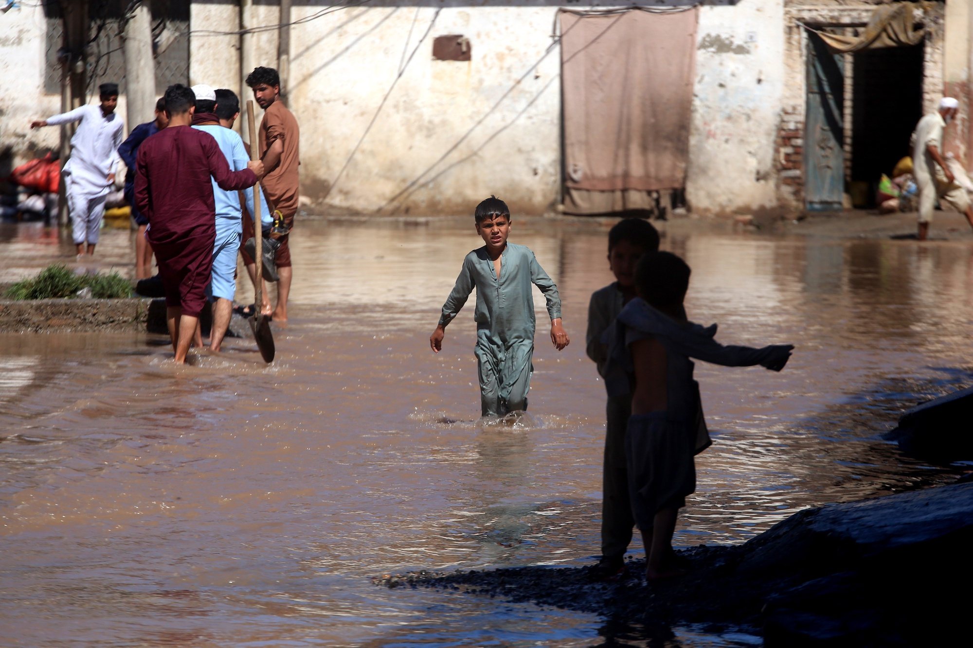 epa11282110 People wade through a flooded street after heavy rain in Charsadda District, Khyber Pakhtunkhwa province, Pakistan, 16 April 2024. Pakistan&#039;s southwest region has been in the grip of heavy rainfall for days, with at least 39 people reported dead. Among the victims were farmers struck by lightning while working in wheat fields, according to authorities. According to the Khyber Pakhtunkhwa (KP) provincial disaster management authority, 32 others have been injured in the last four days due to lightning strikes and incidents related to torrential rains affecting several provinces. Pakistan is among the world&#039;s top 10 countries most-affected by climate change.  EPA/BILAWAL ARBAB