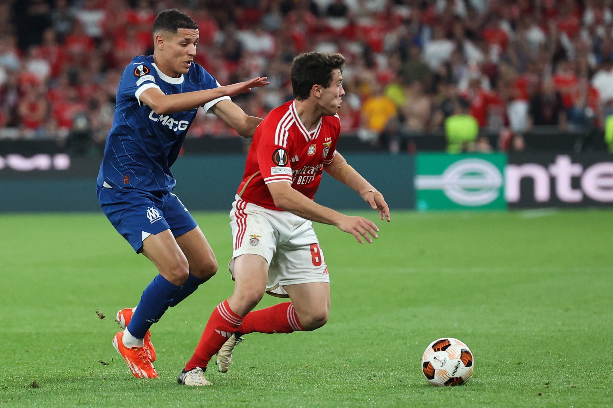 Benfica player Joao Neves (R) in action against Olympique de Marseille Amine Harit during the UEFA Europe League quarter-final first leg soccer match between Benfica and Olympique de Marseille held at Luz Stadium, in Lisbon, Portugal, 11 April 2024. MANUEL DE ALMEIDA/LUSA