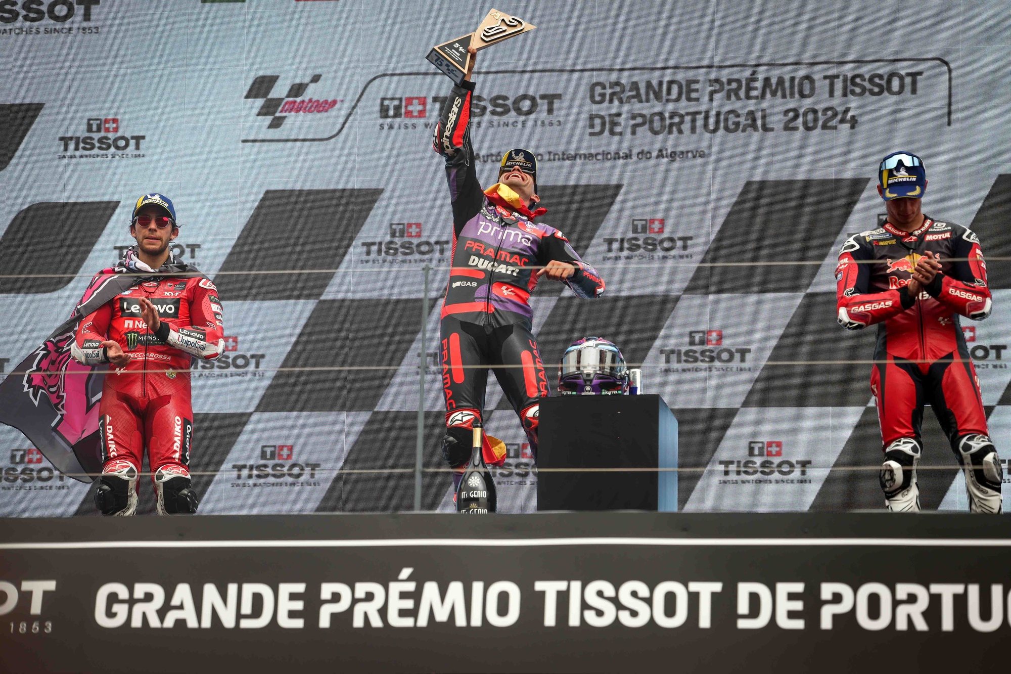 epa11241251 (L-R) Second placed Enea Bastianini of Italy and Ducati Lenovo Team, winner Jorge Martin of Spain and Prima Pramac Racing, and third placed Pedro Acosta of Spain and Red Bull GASGAS Tech3 celebrate on the podium after winning the MotoGP race of the Motorcycling Grand Prix of Portugal, in Portimao, Portugal, 24 March 2024.  EPA/JOSE SENA GOULAO