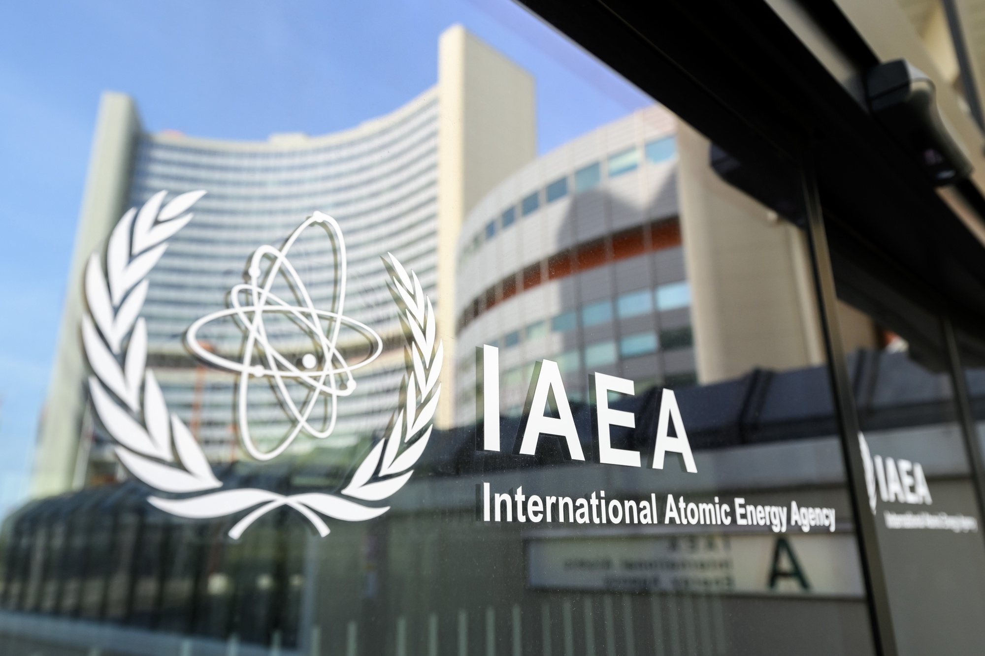 epa11272479 The UNO City is reflected on a door with the IAEA Logo before an International Atomic Energy Agency (IAEA) Board of Governors meeting at the IAEA headquarters of the United Nations seat in Vienna, Austria, 11 April 2024.  EPA/MAX SLOVENCIK