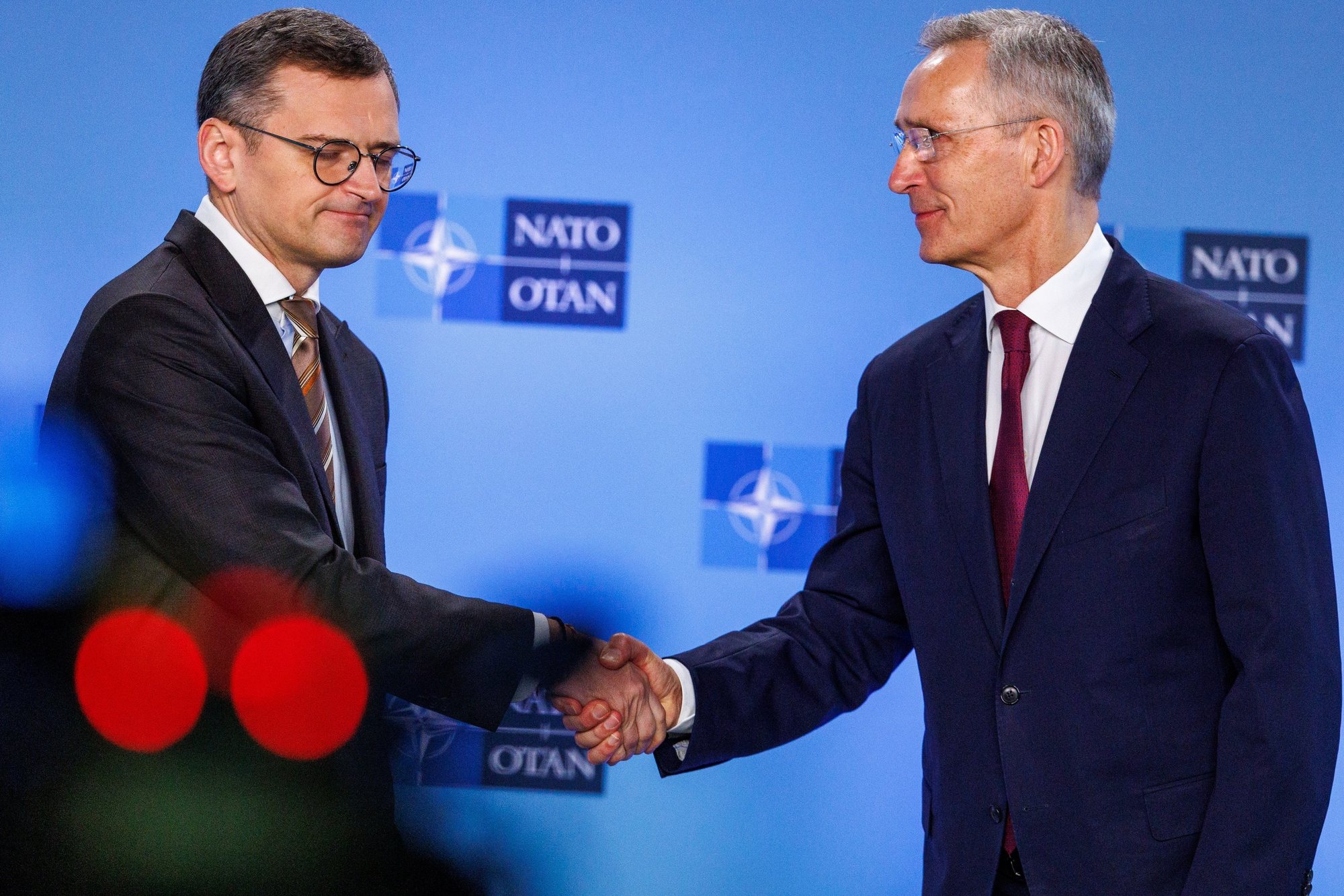 epa11258440 Ukraine&#039;s Foreign Minister Dmytro Kuleba (L) and NATO Secretary-General Jens Stoltenberg shake hands as they deliver a statement during NATO’s 75th anniversary celebration in the Agora to commemorate 75 years of NATO foundation during a North Atlantic Treaty Organization (NATO) Foreign Affairs Ministers meeting in Brussels, Belgium, 04 April 2024. Allied Foreign Affairs Ministers attend a meeting of NATO Ministers of Foreign Affairs at NATO Headquarters in Brussels on 03-04 April as NATO celebrates its 75th anniversary. On 04 April 1949, the 12 founding countries signed the North Atlantic Treaty, called the Washington Treaty. It committed each member to share the risk, responsibilities, and benefits of collective defense.  EPA/OLIVIER MATTHYS