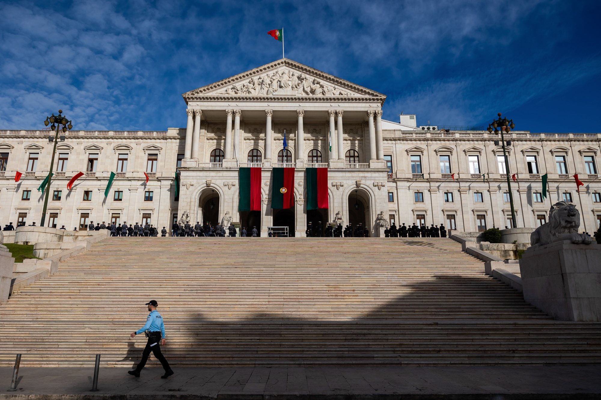 A police officer walks in front of the Portuguese Parliament before the Carnation Revolution 50th anniversary solemn comemorative session, in Lisbon, Portugal, 25 April 2024. Portugal celebrates the 50th anniversary of the Carnation Revolution that ended the authoritarian regime of Estado Novo (New State) that ruled the country between 1926 to 1974. JOSE SENA GOULAO/LUSA
