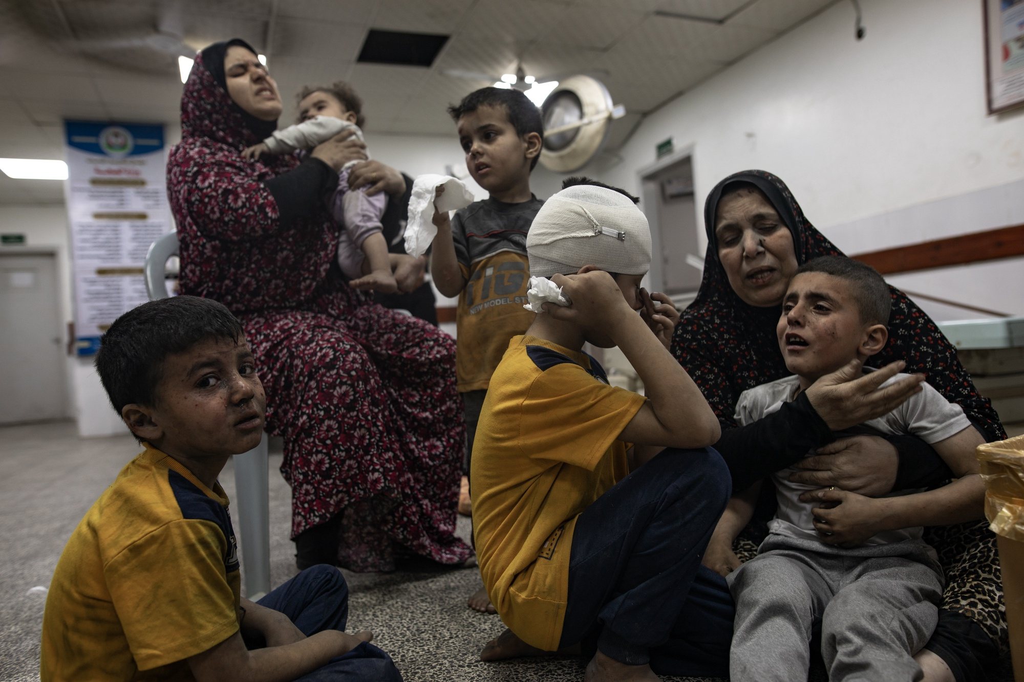 epaselect epa11298945 Children and women wait to receive treatment at Al-Najjar Hospital following an Israeli airstrike that hit their home in southern Gaza in Rafah, southern Gaza Strip, 25 April 2024.  EPA/HAITHAM IMAD