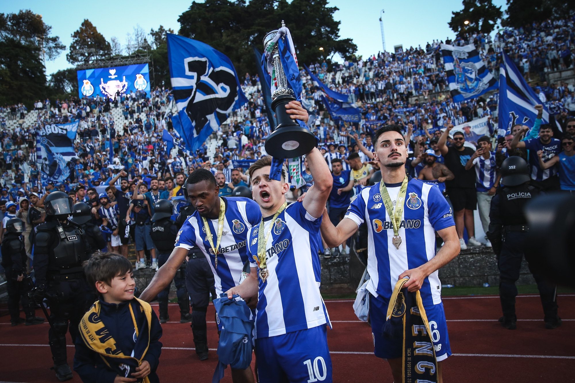 FC Porto players Otavio (C-L), Francisco Conceicao (C), and Stephen Eustaquio (C-R) celebrate with the trophy after winning the Portuguese Soccer Cup final match between FC Porto and Sporting CP at Jamor Nacional stadium in Oeiras, outskirts Lisbon, Portugal, 26 May 2024. RODRIGO ANTUNES/LUSA
