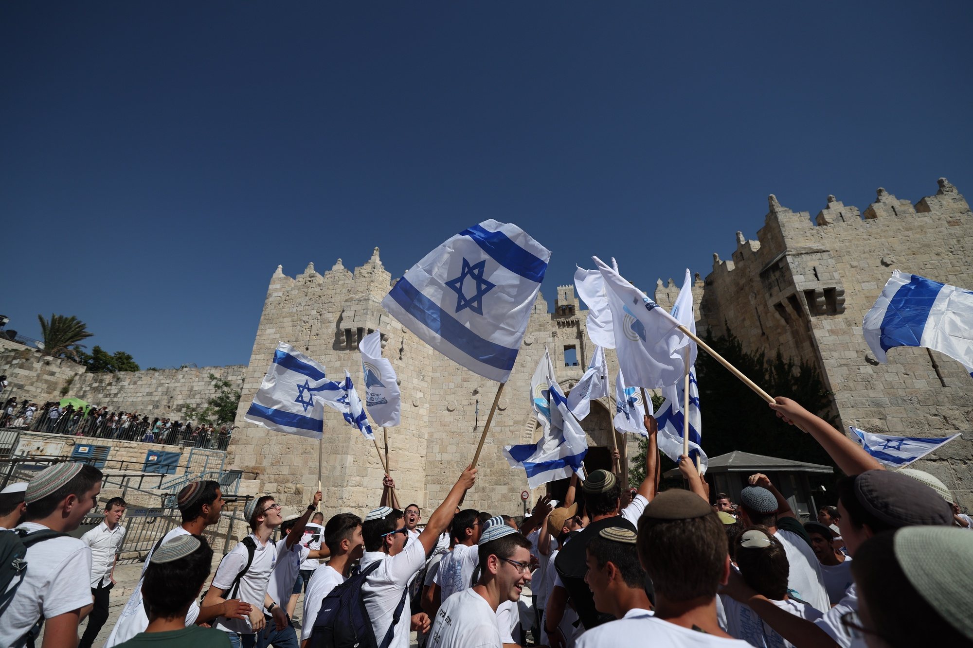 epa11391190 People wave Israeli flags during the controversial &#039;Flag March&#039; at the Damascus Gate in the Old City in Jerusalem, 05 June 2024, as Israel marks its national holiday of Jerusalem Day which commemorates the &#039;reunification&#039; of Jerusalem as Israel took control of the old city of Jerusalem and East Jerusalem following the Six-Day War of 1967.  EPA/ATEF SAFADI