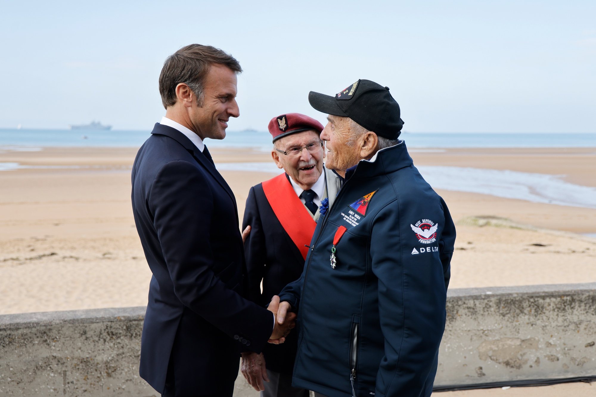 epa11394147 France&#039;s President Emmanuel Macron (L) meets with US WWII veteran Andy Negra (R), and French veteran Achille Muller, last survivor of the Free French Forces, during the International commemorative ceremony at Omaha Beach marking the 80th anniversary of the World War II &#039;D-Day&#039; Allied landings in Normandy, in Saint-Laurent-sur-Mer, in northwestern France, 06 June 2024. The D-Day ceremonies on June 6 mark the 80th anniversary since the launch of &#039;Operation Overlord&#039;, a vast military operation by Allied forces in Normandy, which turned the tide of World War II, eventually leading to the liberation of occupied France and the end of the war against Nazi Germany.  EPA/LUDOVIC MARIN / POOL  MAXPPP OUT