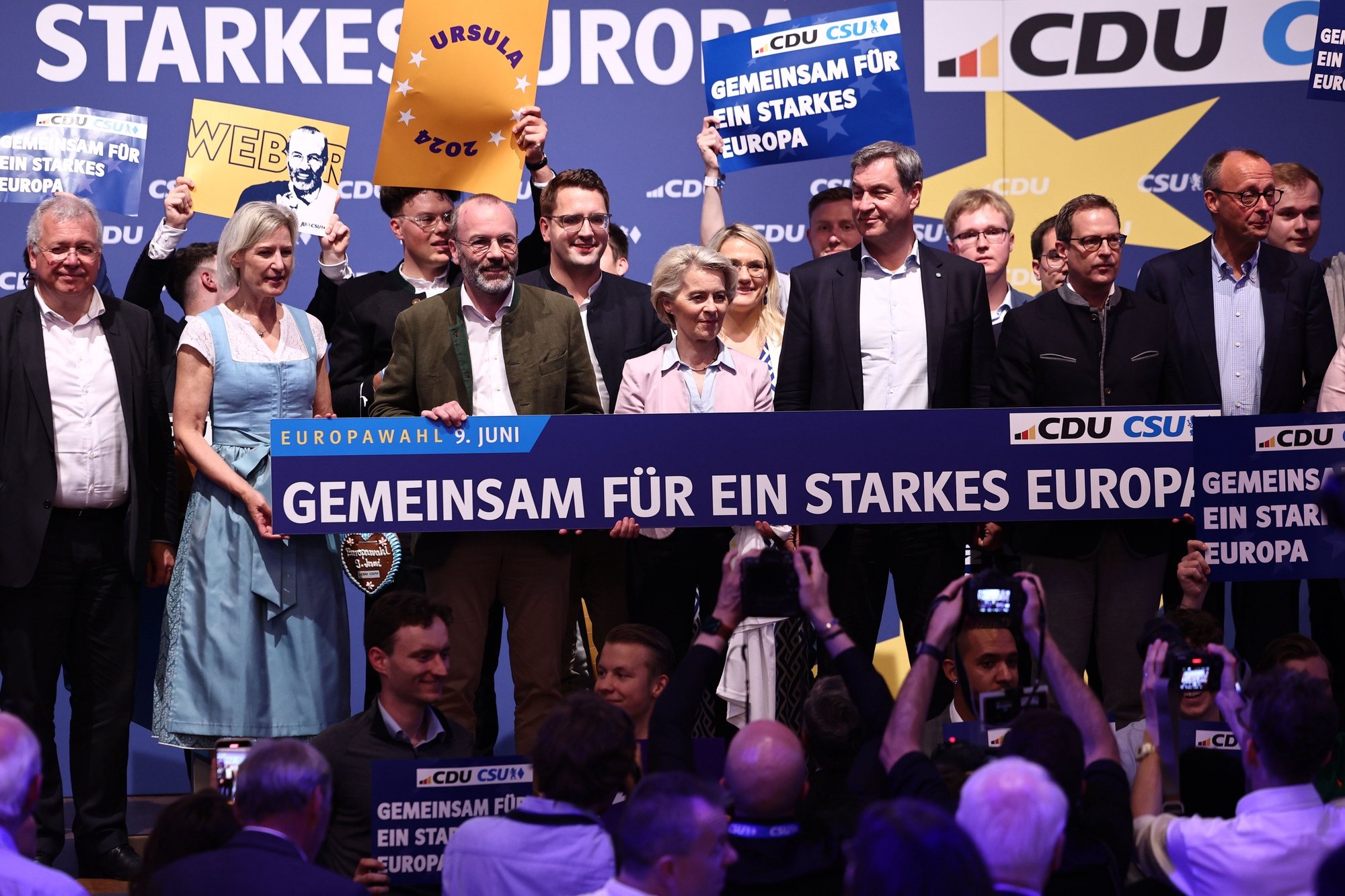 epa11396417 CSU&#039;s top candidate in the European elections, the EPP Group Chairman in the European Parliament Manfred Weber (C-L), European Commision President Ursula von der Leyen (C) and Bavarian Premier Markus Soeder (C-R) hold a banner saying &#039;together for a strong Europe&#039; on the stage, at the end of the final campaign rally of CDU and CSU for the European elections in Munich Germany, 07 June 2024. This year&#039;s European Parliament elections are scheduled across EU member states from 06 to 09 June.  EPA/ANNA SZILAGYI