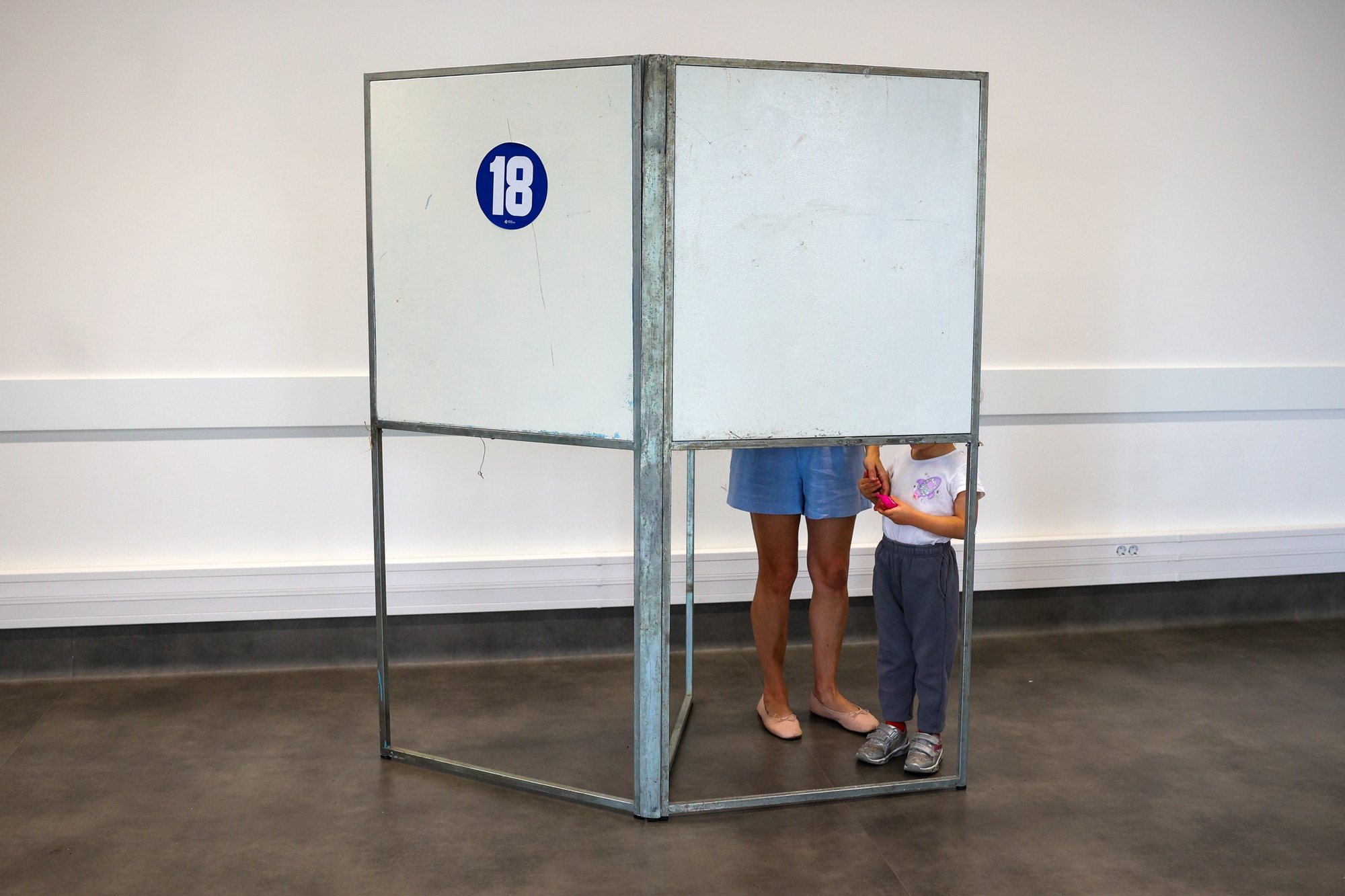 A woman accompanied by his child votes for the European Elections at a polling station in Lisbon, Portugal, 09 June 2024. More than 10.8 million registered voters in Portugal and abroad go to the polls today to choose 21 of the 720 members of the European Parliament. ANTONIO COTRIM/LUSA