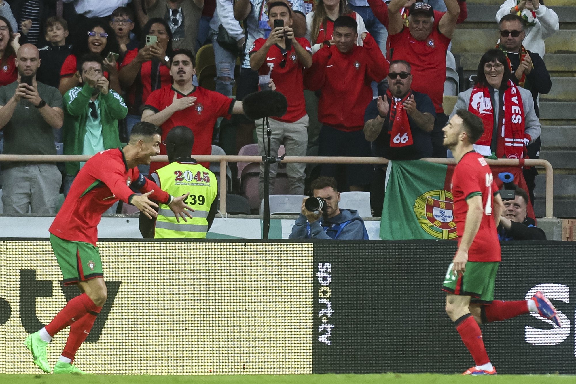 Portugal player Cristiano Ronaldo (L) celebrates after scoring a goal against Ireland during their soccer international friendly soccer match held at Estadio Municipal of Aveiro, in Aveiro, Portugal, 11 June 2024. PAULO NOVAIS/LUSA