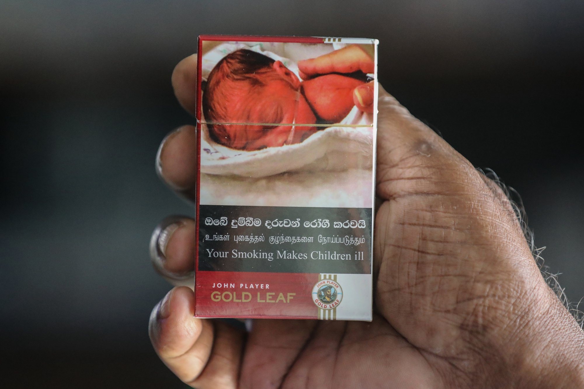 epa11379993 A Sri Lankan vendor shows cigarette packets carrying pictorial health warnings in Colombo, Sri Lanka, 30 May 2024. According to the Alcohol and Drug Information Centre (ADIC) in Sri Lanka, cigarettes are responsible for approximately 50 preventable deaths each day, leading to an estimated 20,000 preventable deaths annually. Despite this, around 1.5 million people in the country continue to use cigarettes.  EPA/CHAMILA KARUNARATHNE