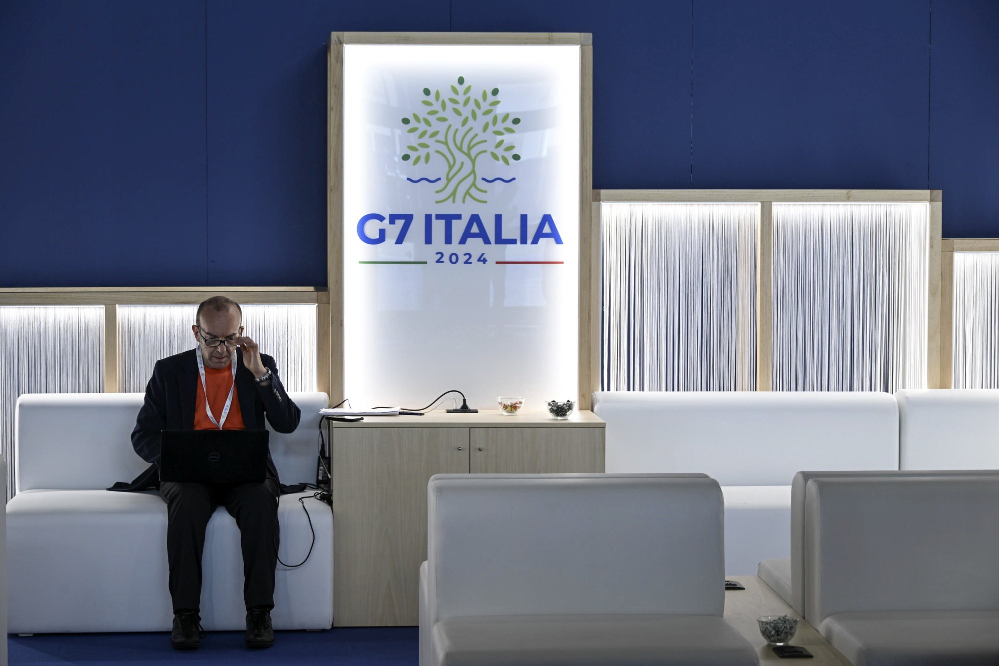 epa11405669 A journalist sits in the media center set up at the G7 Summit venue in Borgo Egnazia resort, near Bari, southern Italy, 12 June 2024. The G7 summit will bring together the Group of Seven member states leaders in Borgo Egnazia resort in southern Italy from 13 to 15 June 2024.  EPA/CIRO FUSCO