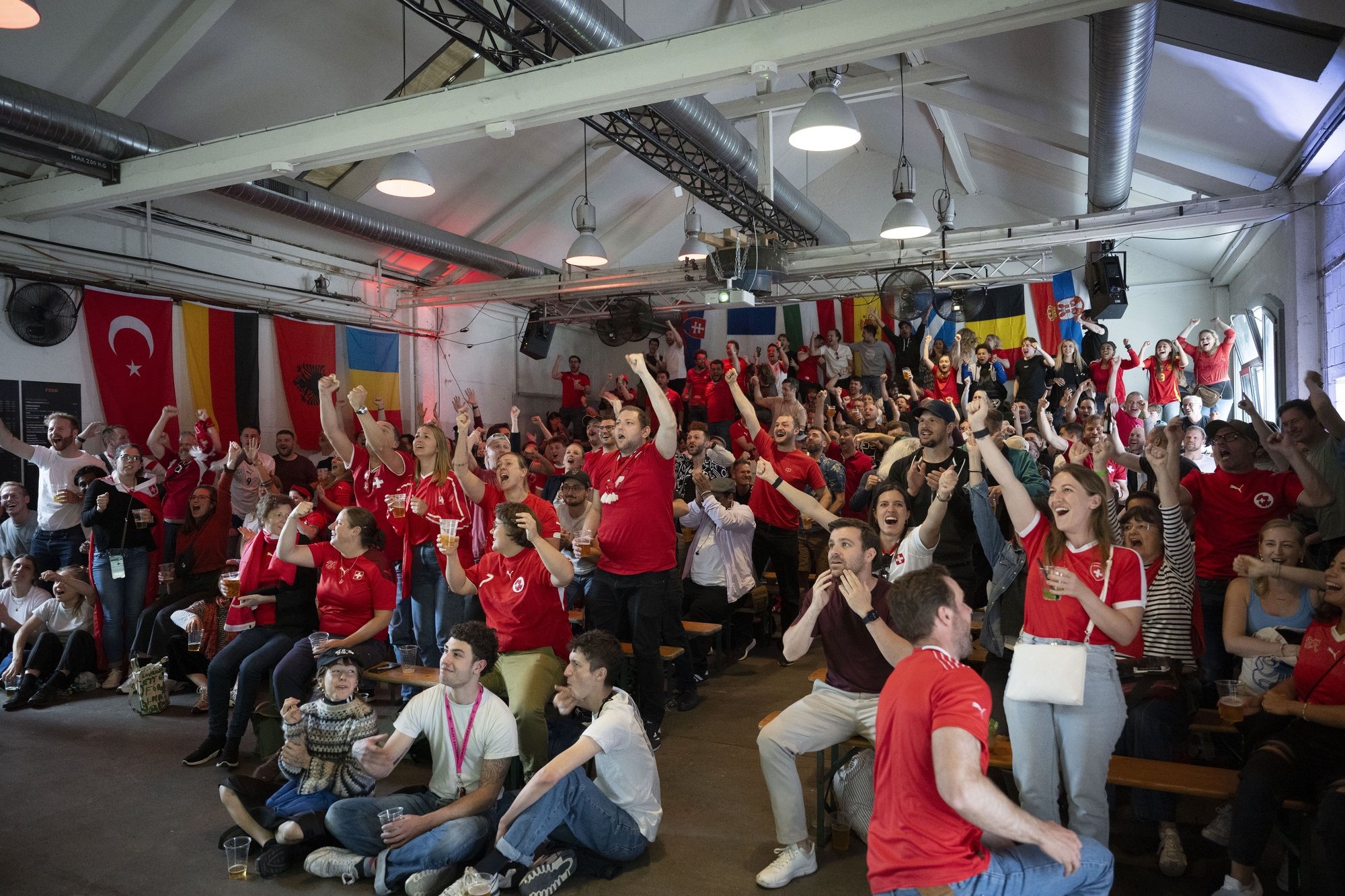 epa11412176 Swiss soccer fans celebrate the 0-2 goal during the live broadcast of the UEFA EURO 2024 soccer match between Hungary and Switzerland at the Amboss Rampe in Zurich, Switzerland, 15 June 2024.  EPA/CHRISTIAN BEUTLER