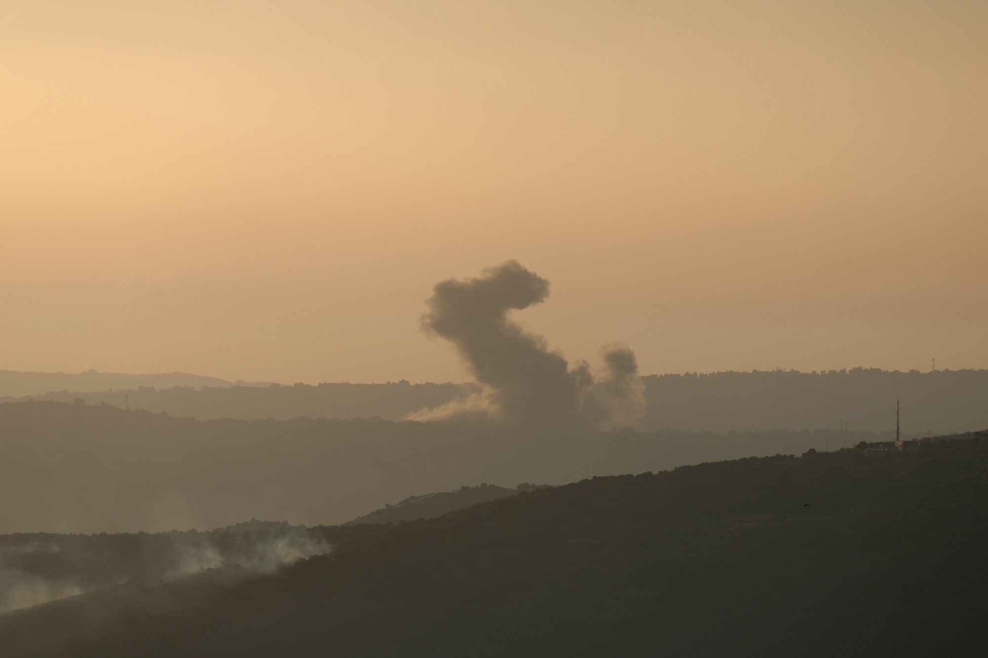 epa11428533 Smoke rises as a result of an Israeli air strike in the southern Lebanese town of Al  Khiam, as seen from northern Israel, 21 June 2024. According to the Israeli army, several rocket launches were identified crossing from Lebanon into northern Israel. No injuries were reported, the Israely army said.  EPA/ATEF SAFADI