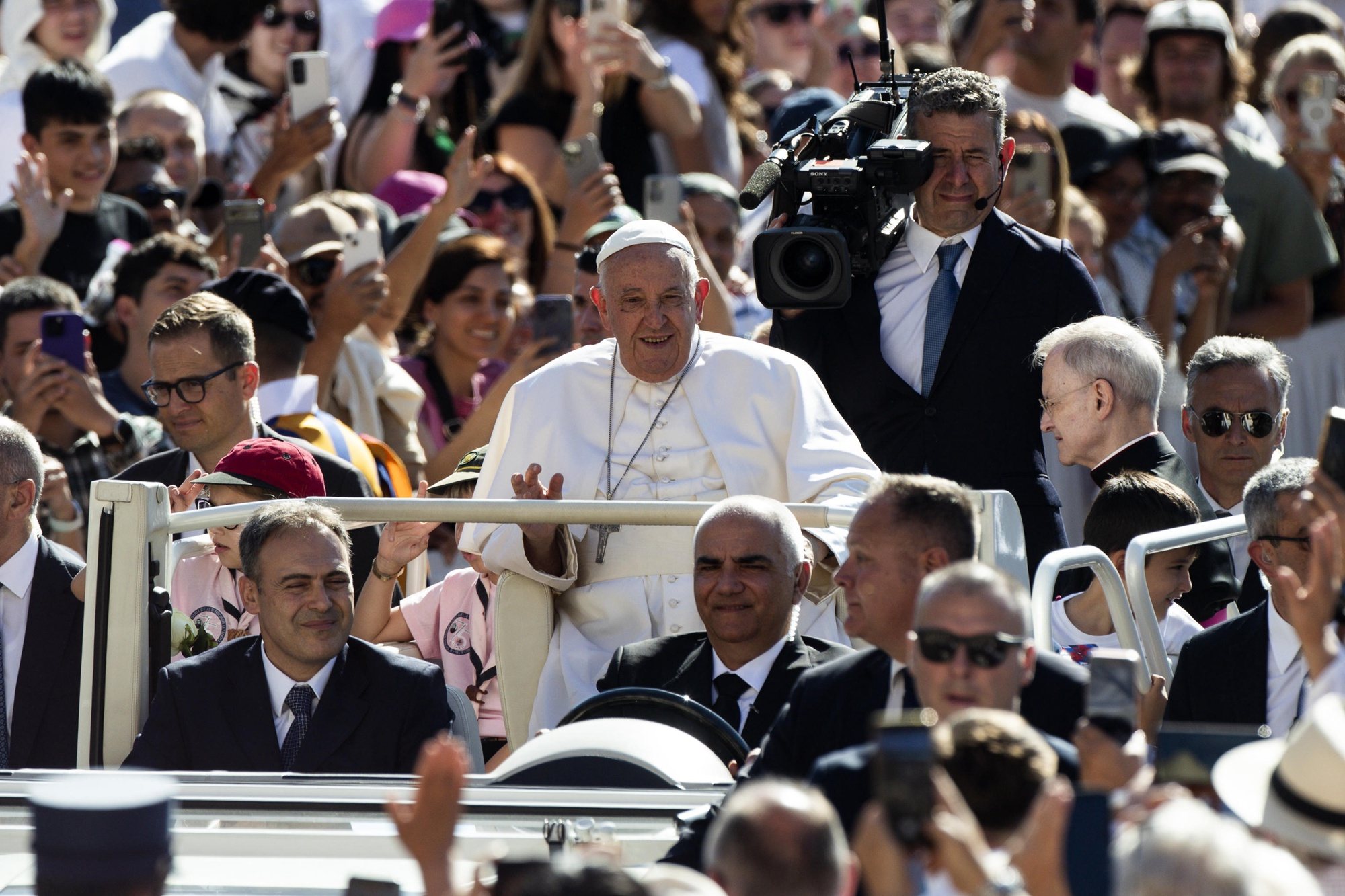 epa11438437 Pope Francis (C) greets faithful during the weekly general audience in Saint Peters Square, Vatican City, 26 June 2024.  EPA/ANGELO CARCONI