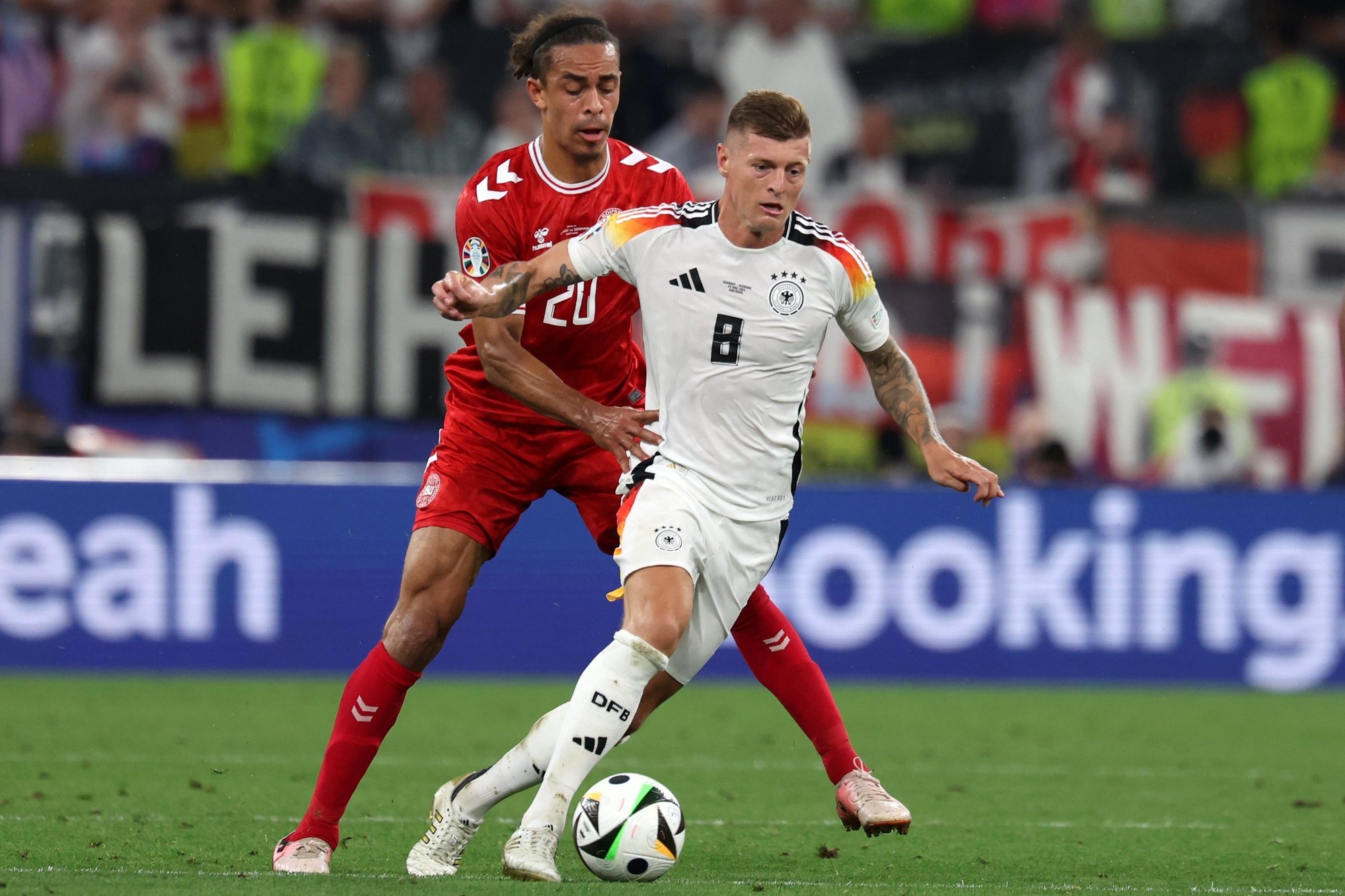 epa11446358 Toni Kroos of Germany (R) in action against Yussuf Pulsen of Denmark during the UEFA EURO 2024 Round of 16 soccer match between Germany and Denmark, in Dortmund, Germany, 29 June 2024.  EPA/CHRISTOPHER NEUNDORF
