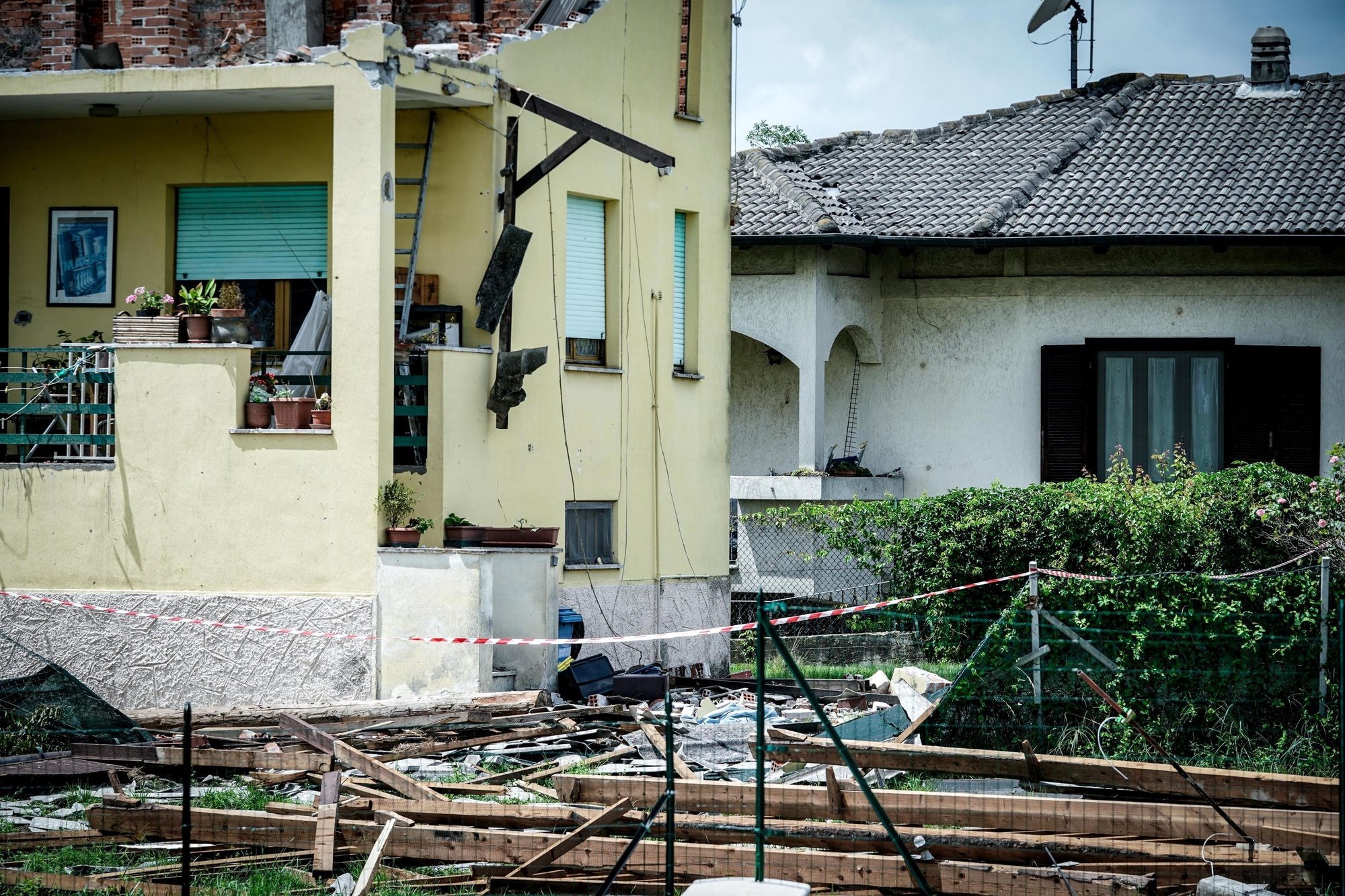 epa11447108 A building with its roof damaged by a whirlwind in Busano Canavese, near Turin, Italy, 30 June 2024. Storms hit the Alpine valleys of Turin, in particular the Orco Valley, on 29 June, causing landslides, floods, and overflowing streams, and leaving people displaced and some localities isolated. Dozens of people had to leave their places of residence late on 29 June due to the severe weather.  EPA/TINO ROMANO