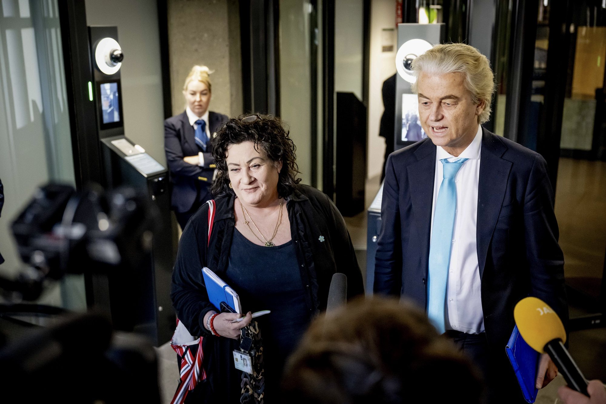 epa11403712 Party for Freedom (PVV) leader Geert Wilders  (R) and Farmer-Citizen Movement (BBB) party leader Caroline van der Plas (L) speak to the press after formation talks with the coalition parties PVV, VVD, NSC, BBB and formateur Richard van Zwol (not pictured) and prospective Prime Minister Dick Schoof (not pictured) in the Hague, the Netherlands, 11 June 2024. After weeks of consultation, the four parties PVV, VVD, NSC and BBB have reached an agreement on the distribution of cabinet posts. Former top civil servant Dick Schoof is set to become prime minister of the new government. Wilders has announced that the assigning of cabinet posts is completed.  EPA/ROBIN UTRECHT
